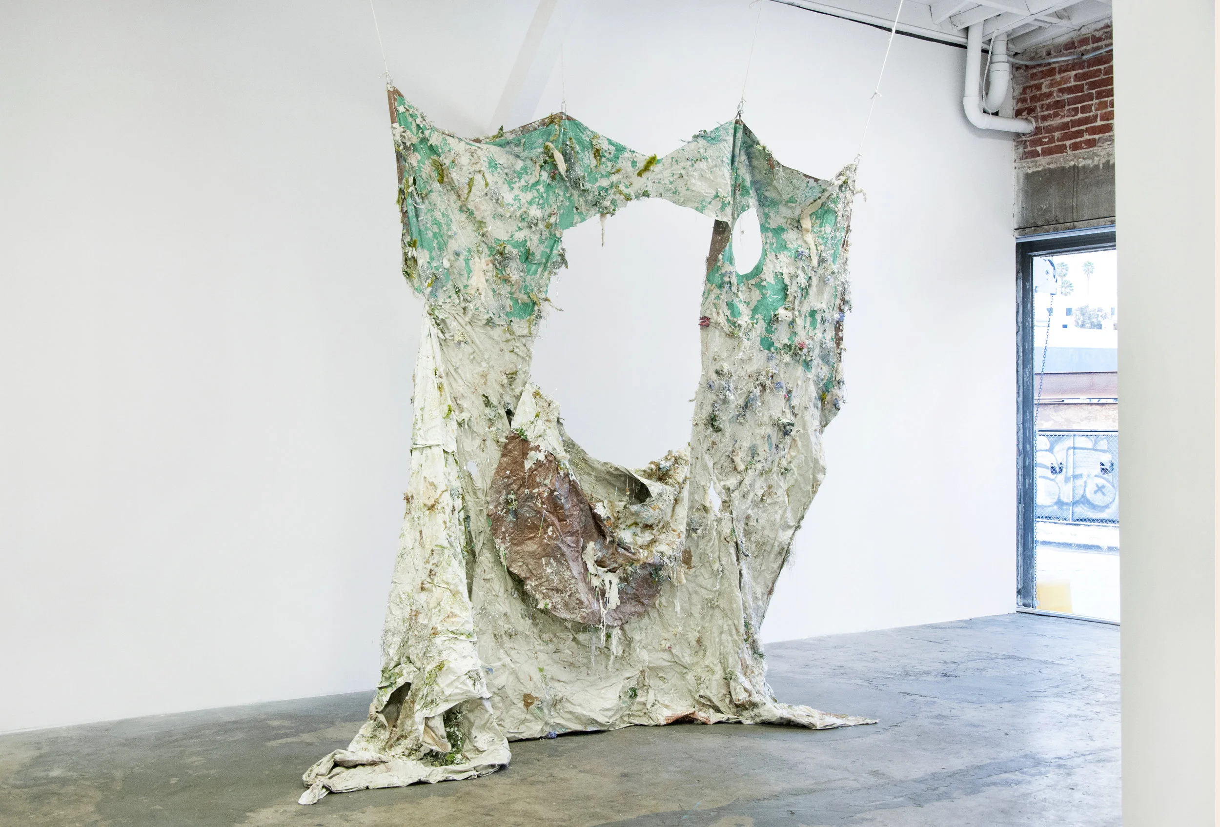 Beach Blanket, materials: tarp, duvet cover, fur, tinsel, ribbon, fake leaves, flowers, beads, Christmas ornament, moss, gems, glitter, feathers, plastic doves, gold leaf, sand 96” x 96”