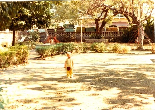 18 months old, fashionable in yellow with Indian Purse, Making my Playground Debut. Poona, INDIA 1980