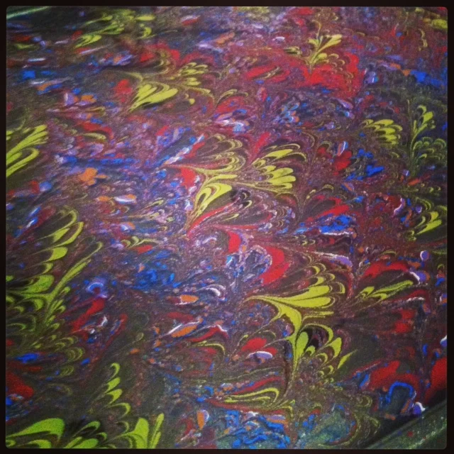 Combed and raked paint floating on size.