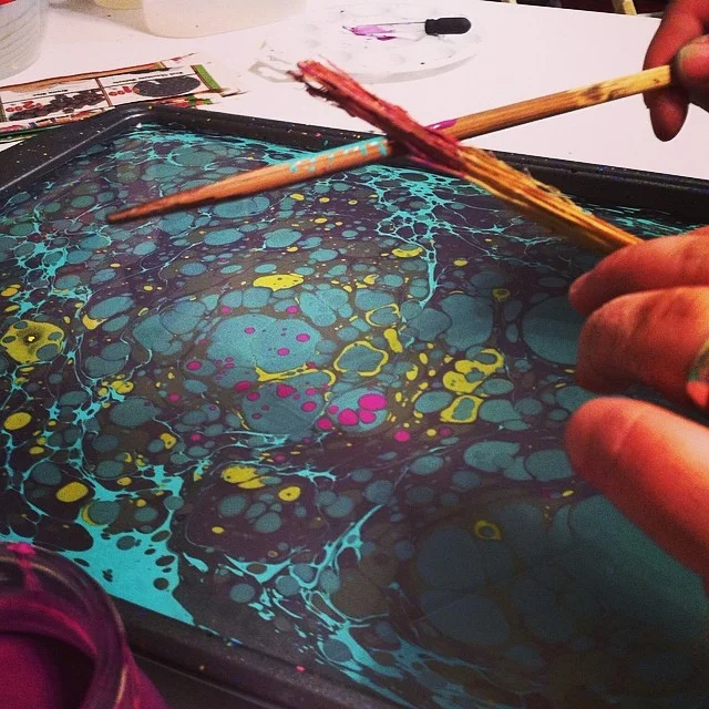 Paint floating on size, a stone marble pattern.