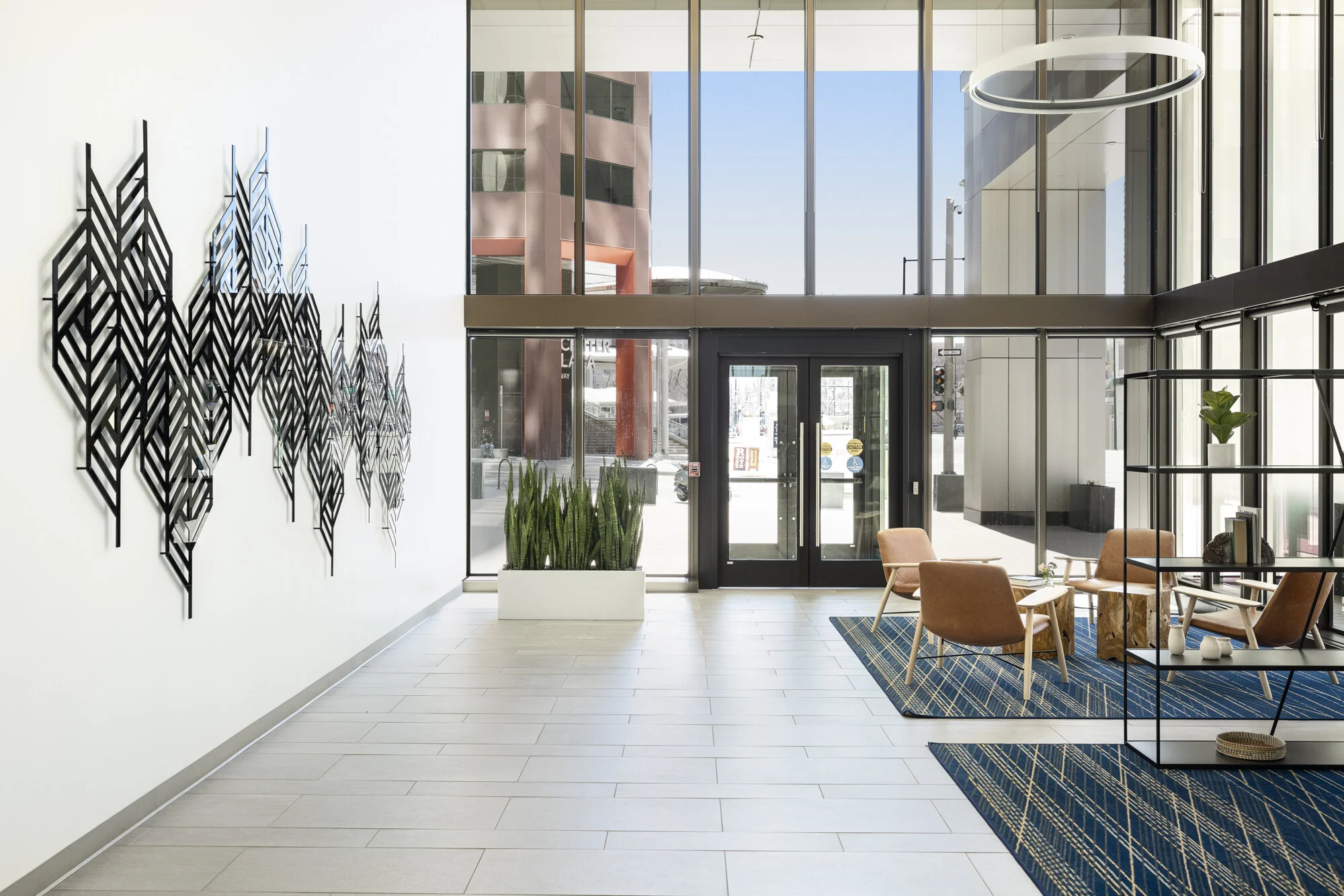 “Here We Are”, 7 panel installation, Glossy black & silver mirror acrylic, 1600 Broadway, Downtown Denver, CO, 8'x20'x3", 2020. Photo by  Third Dune Productions courtesy of Hey Hue Art