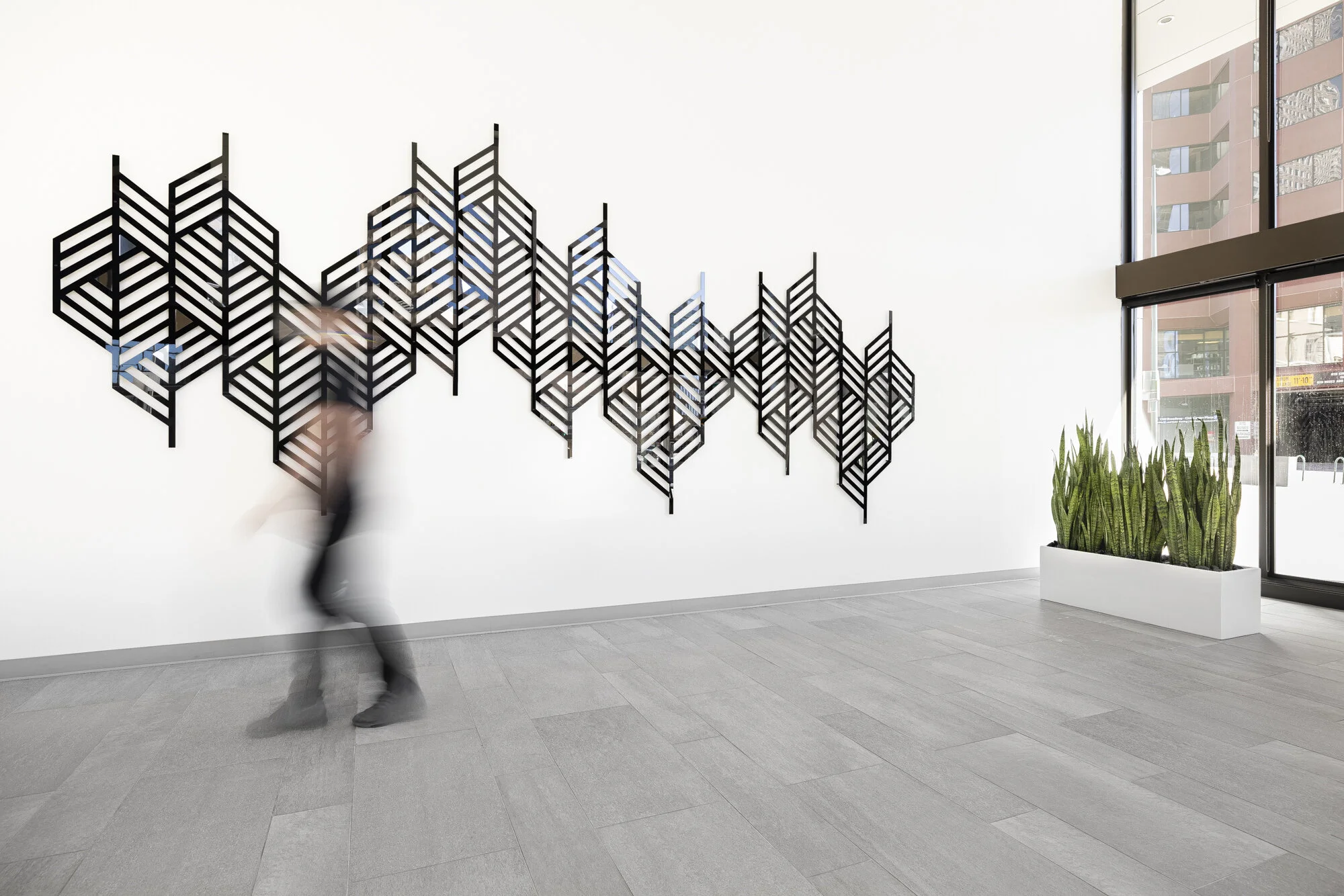 “Here We Are”, 7 panel installation, Glossy black & silver mirror acrylic, 1600 Broadway, Denver, CO, 8'x20'x3", 2020. Photo by  Third Dune Productions courtesy of Hey Hue Art