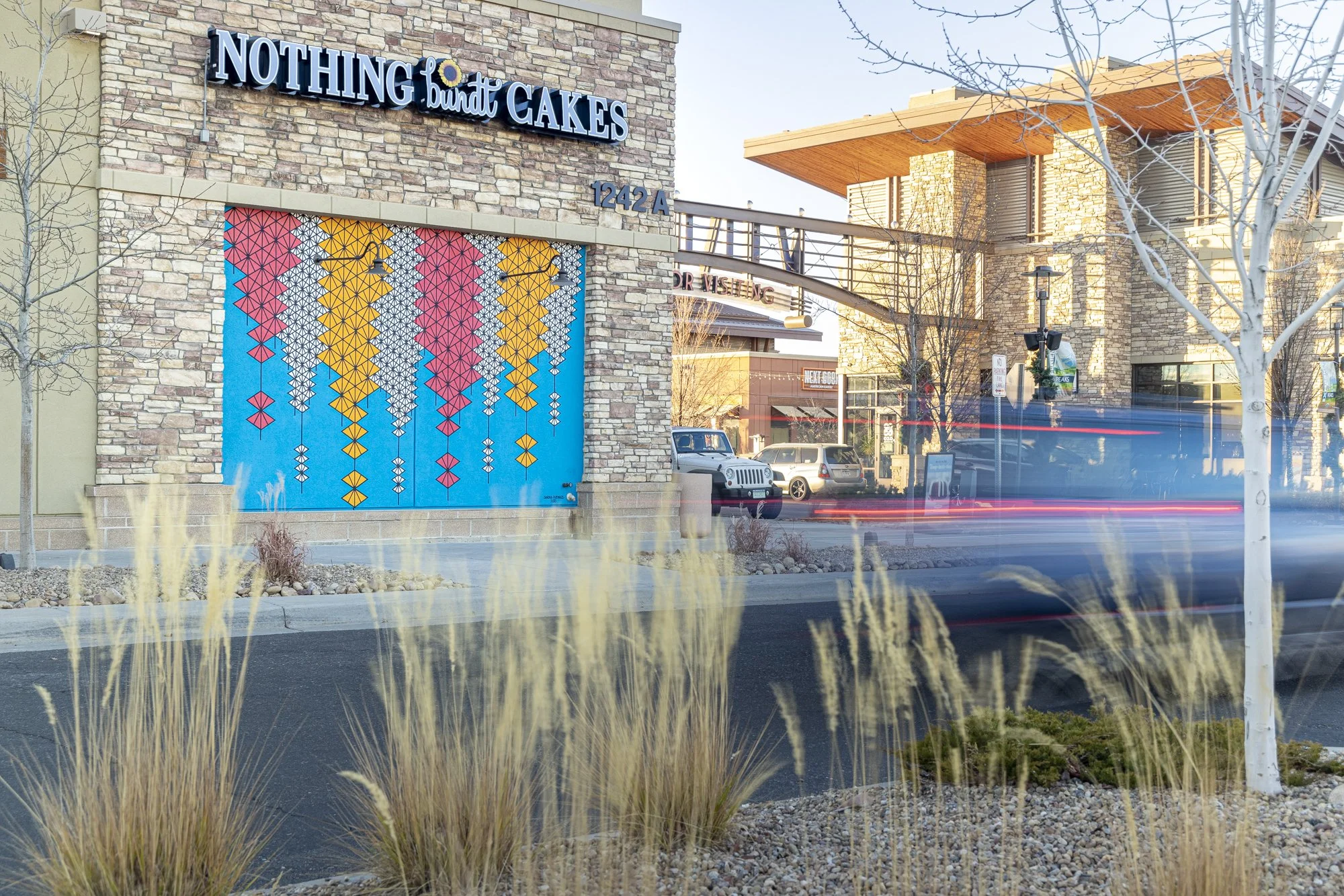 "We Can Make it Easy," (View 2) 16'x10'5", Acrylic paint, Village at the Peaks, Longmont, CO, 2021. Photo by Third Dune Productions