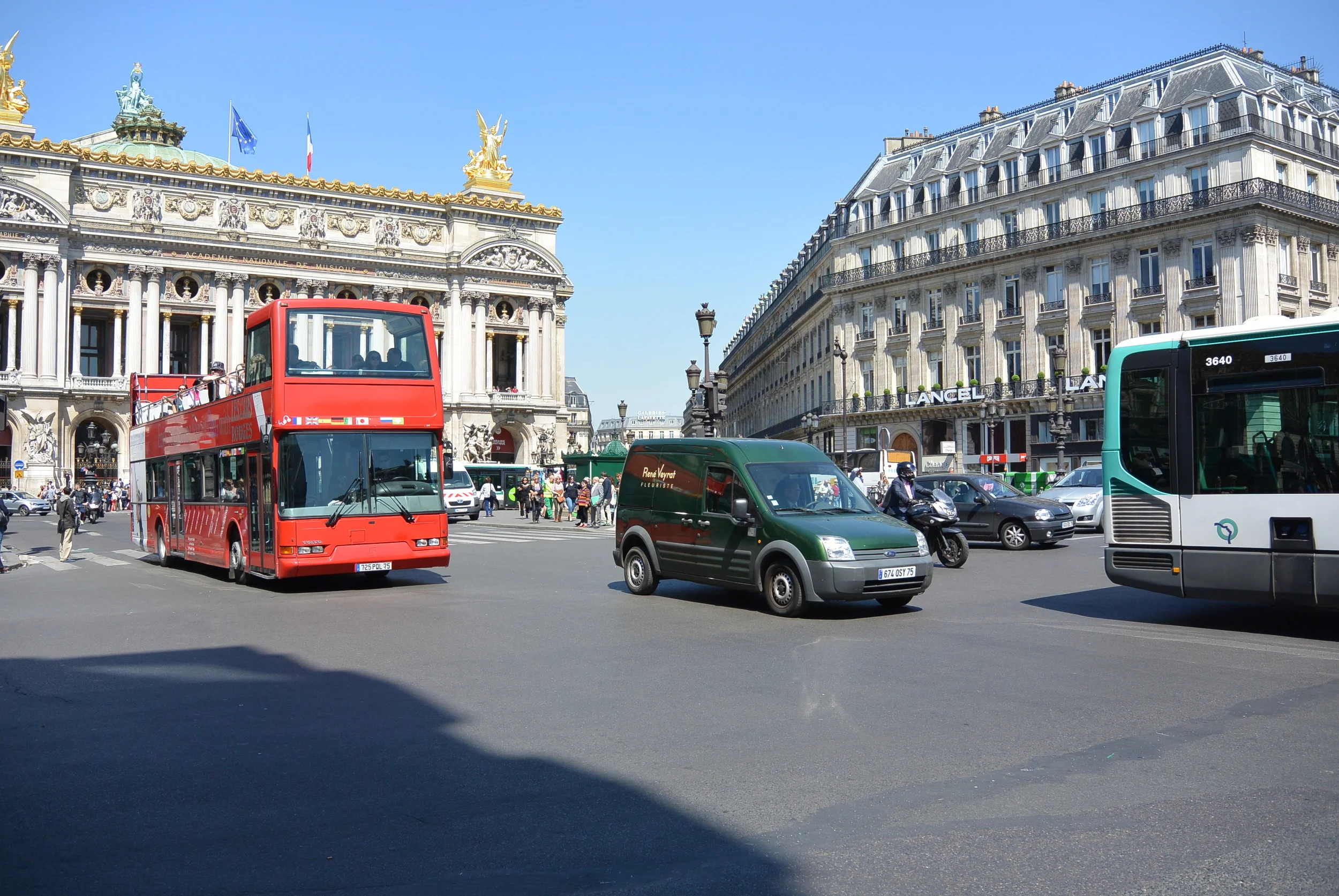 ​things are hopping in Paris, love the red bus.
