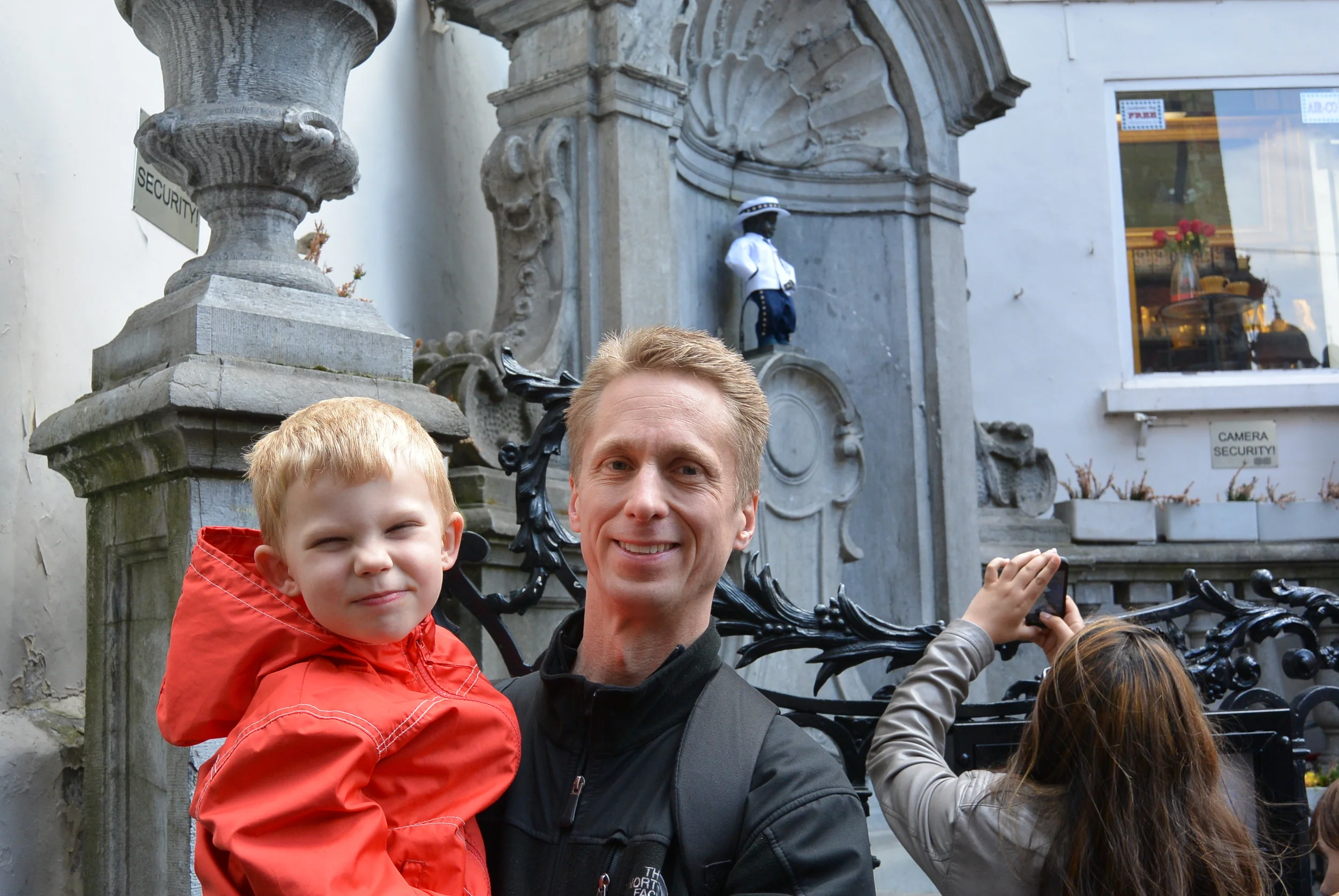 ​The boys next to the dressed up Mannekan pis.