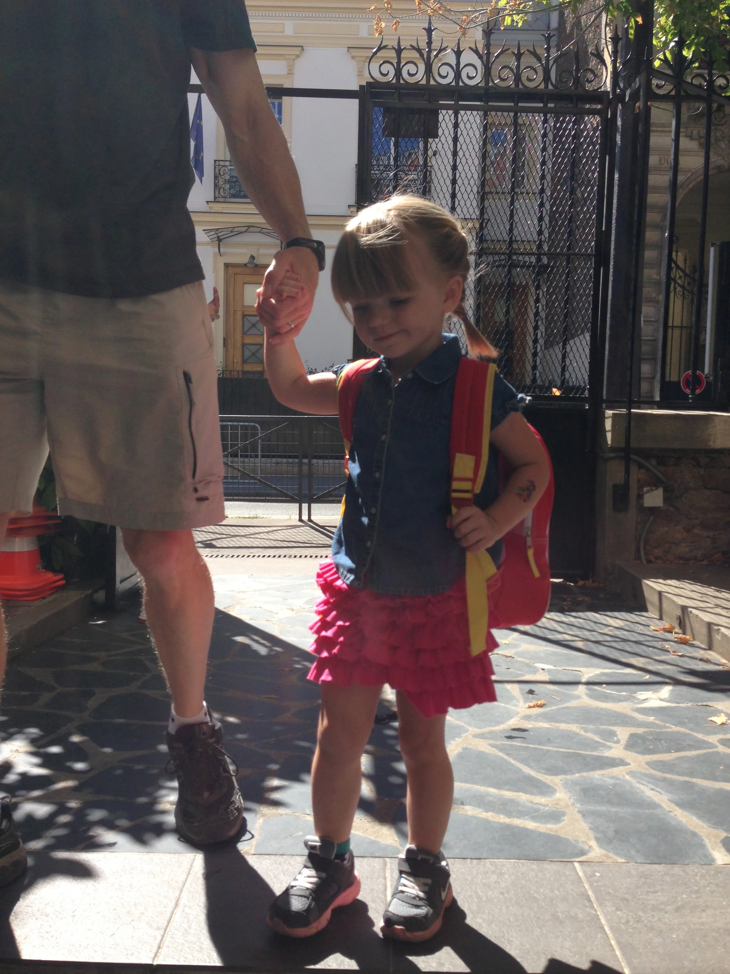 Holding daddy's hand on the way in.