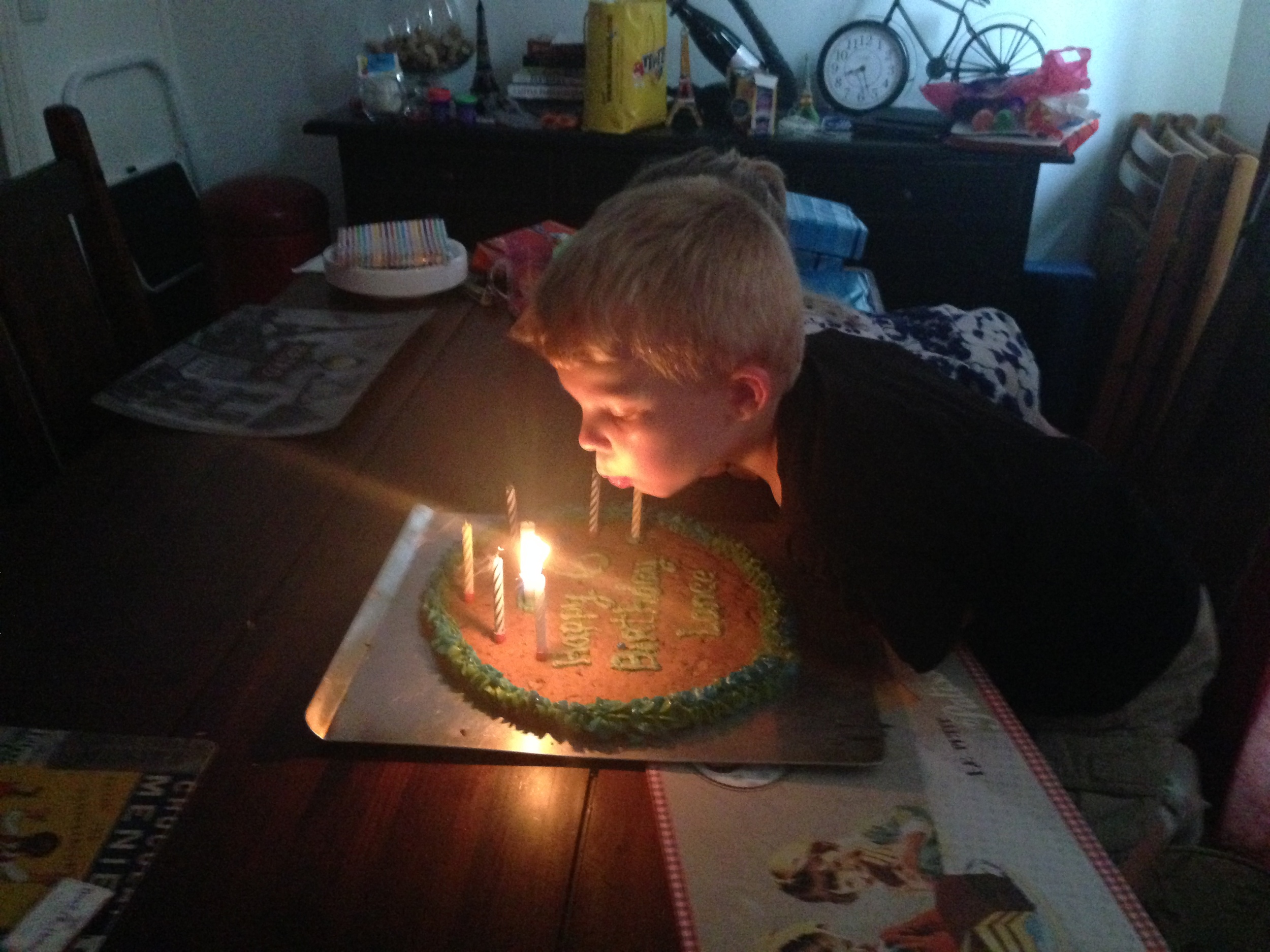 Lance blowing out candles for the 2nd time. &nbsp;I made him a big cookie.