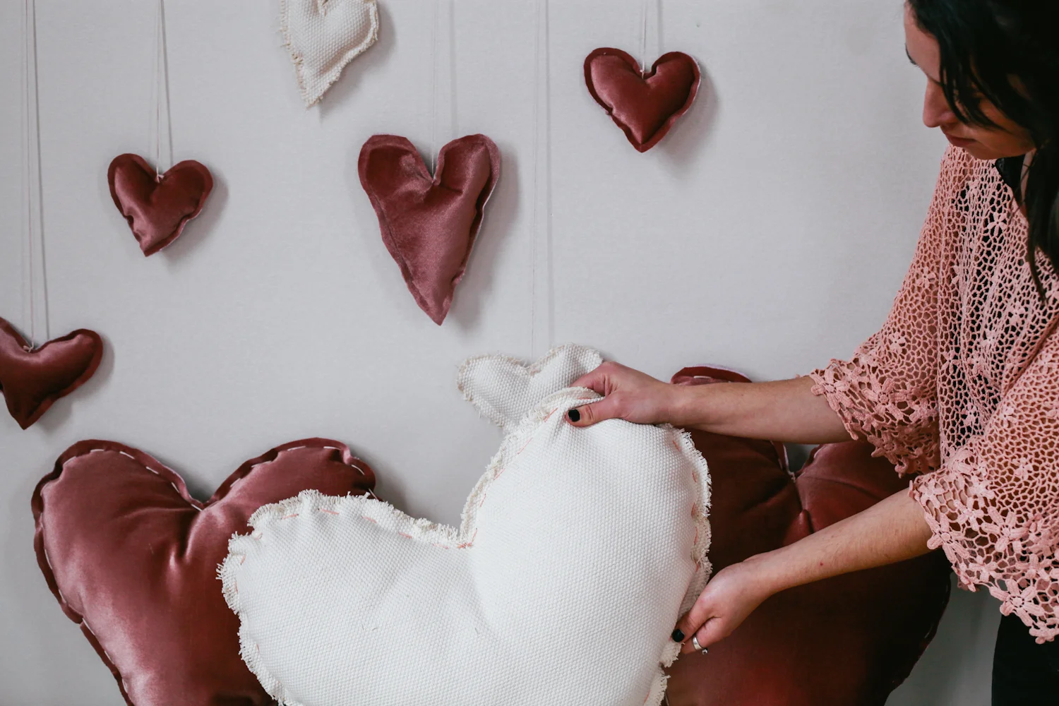 woman holding cute valentine diy pillows holiday