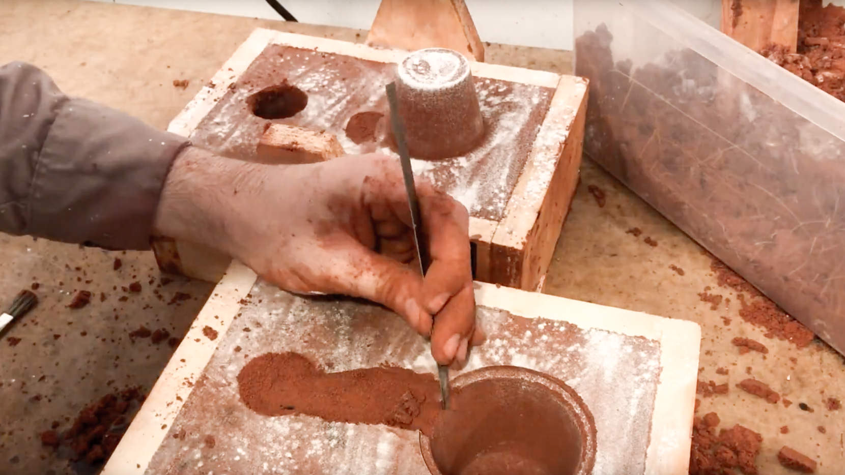 Making the Sand Molds. The red sand you see is Petrobond.