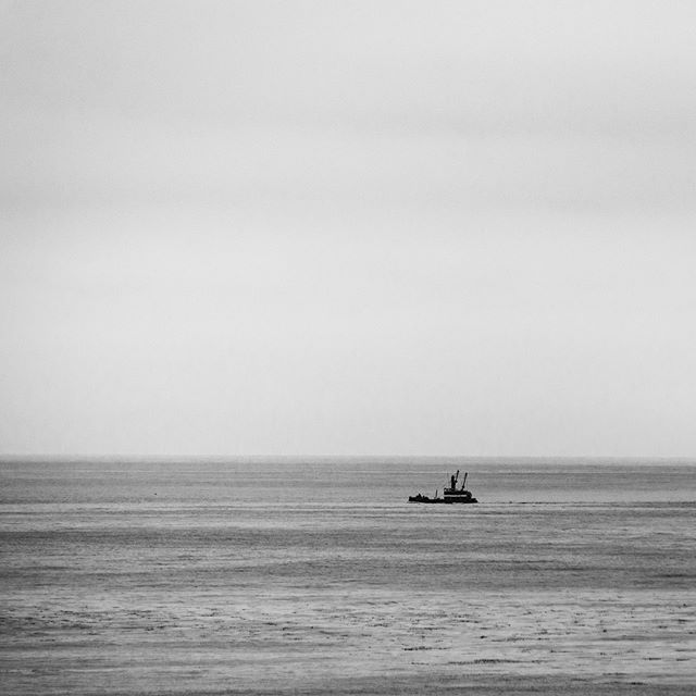 The lonely fishing boat. #fishing #ocean #panoramic #pacificbeach #blackandwhite #boat #alone #peacful #nikonusa #sigmaphoto #landscape #oceanscape #raymondvestalphotography