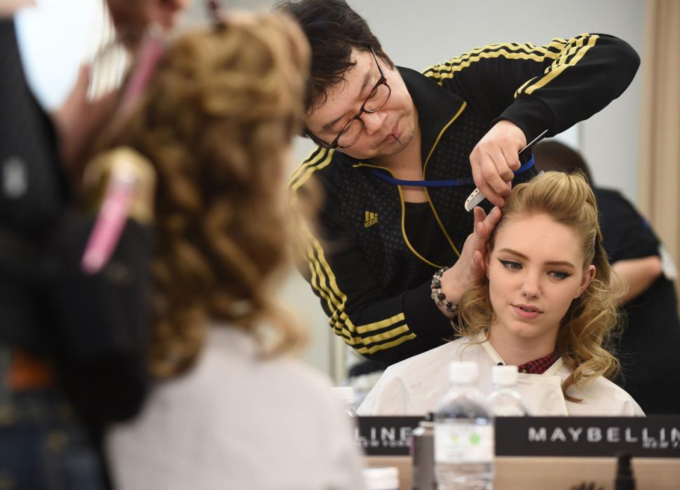 MUA Ko Saito works with Kali Myronenko during Tokyo Fashion Week | Toru Yamanaka/AFP/Getty Images