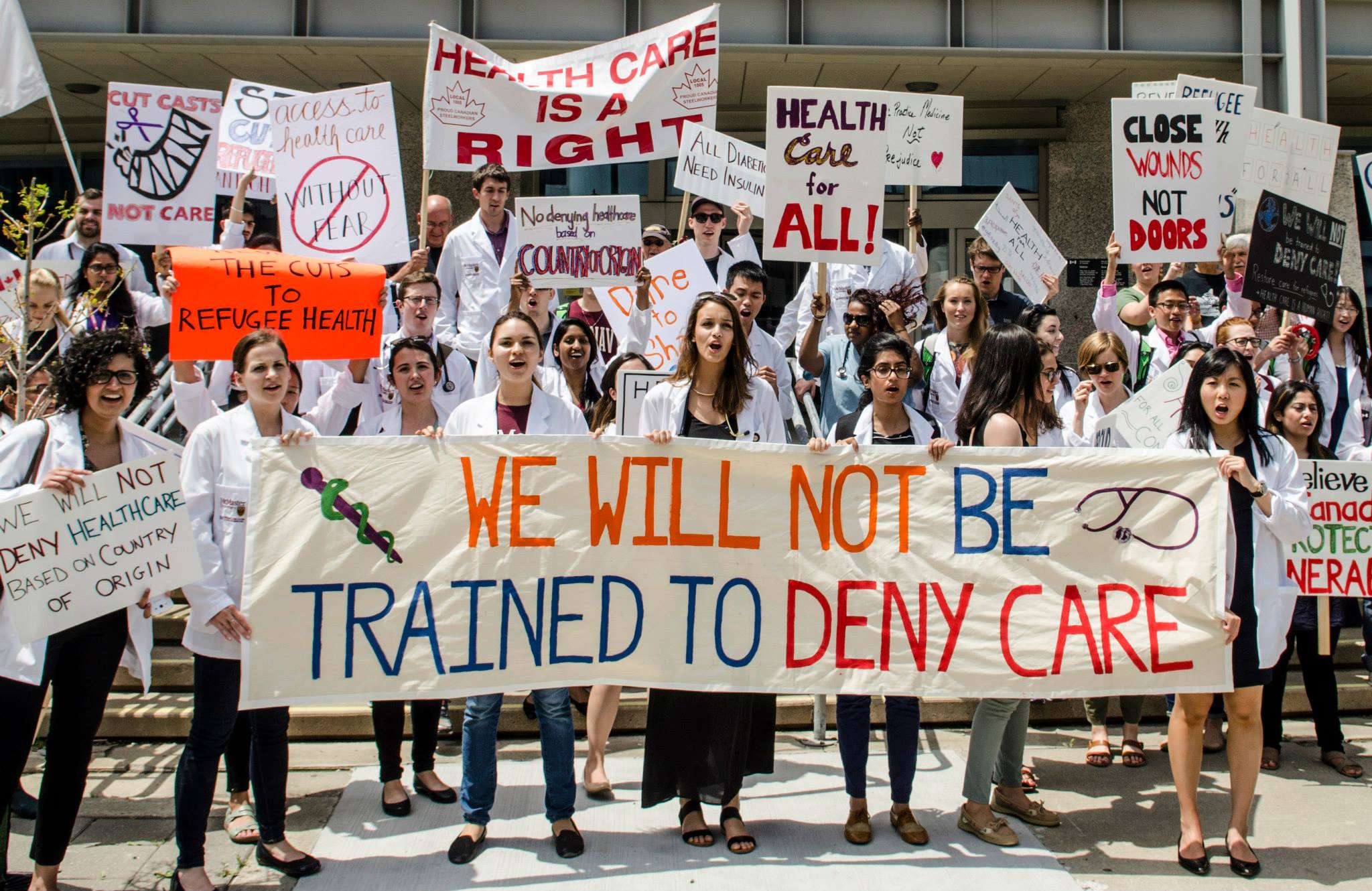 Nicole with fellow McMaster medical students, and Hamilton physicians, nurses, allied health staff, family and friends uniting on June 15th, 2015 for the National Day of Action for Refugee Health. "We openly denounced the federal government’s cuts to the Interim Federal Health Program’s coverage of refugee healthcare. We will not be taught to deny care. More info at http://www.doctorsforrefugeecare.ca/day-of-action-june-15-2015.html ."