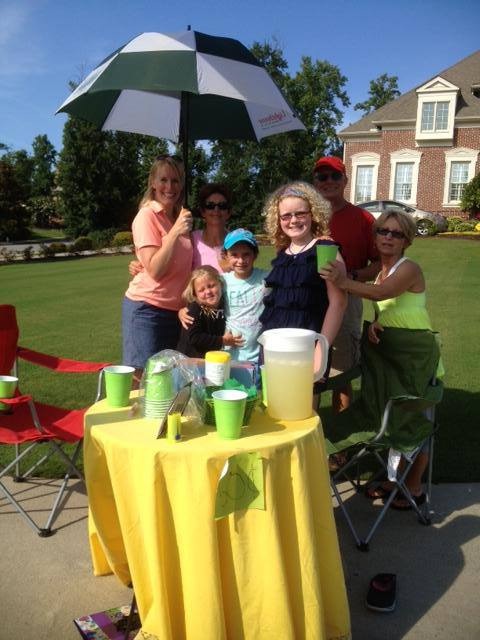 A family hosting a LemonAide stand to raise funds to fight CP!