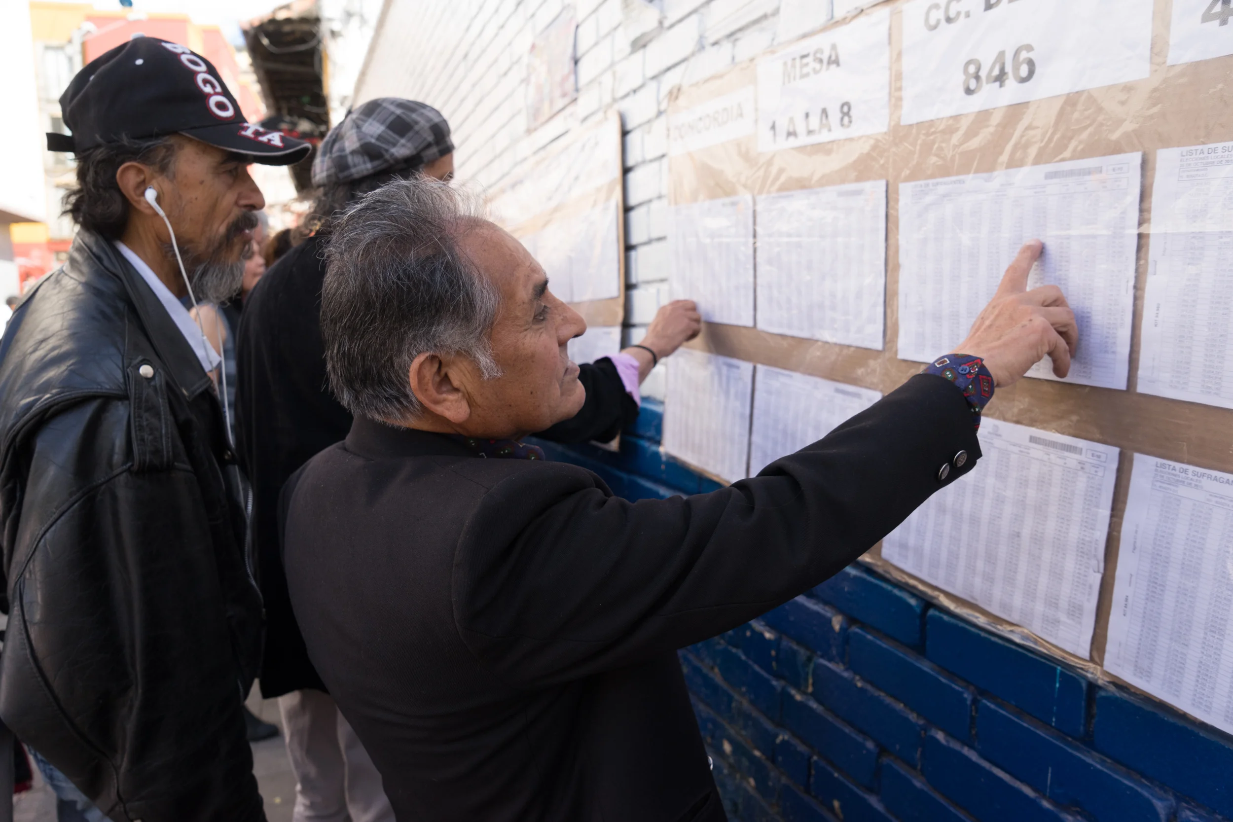 People look for their name at a ballot list in order to cast their vote during Colombian elections for mayor and governor. Bogota, Colombia. October 2015.