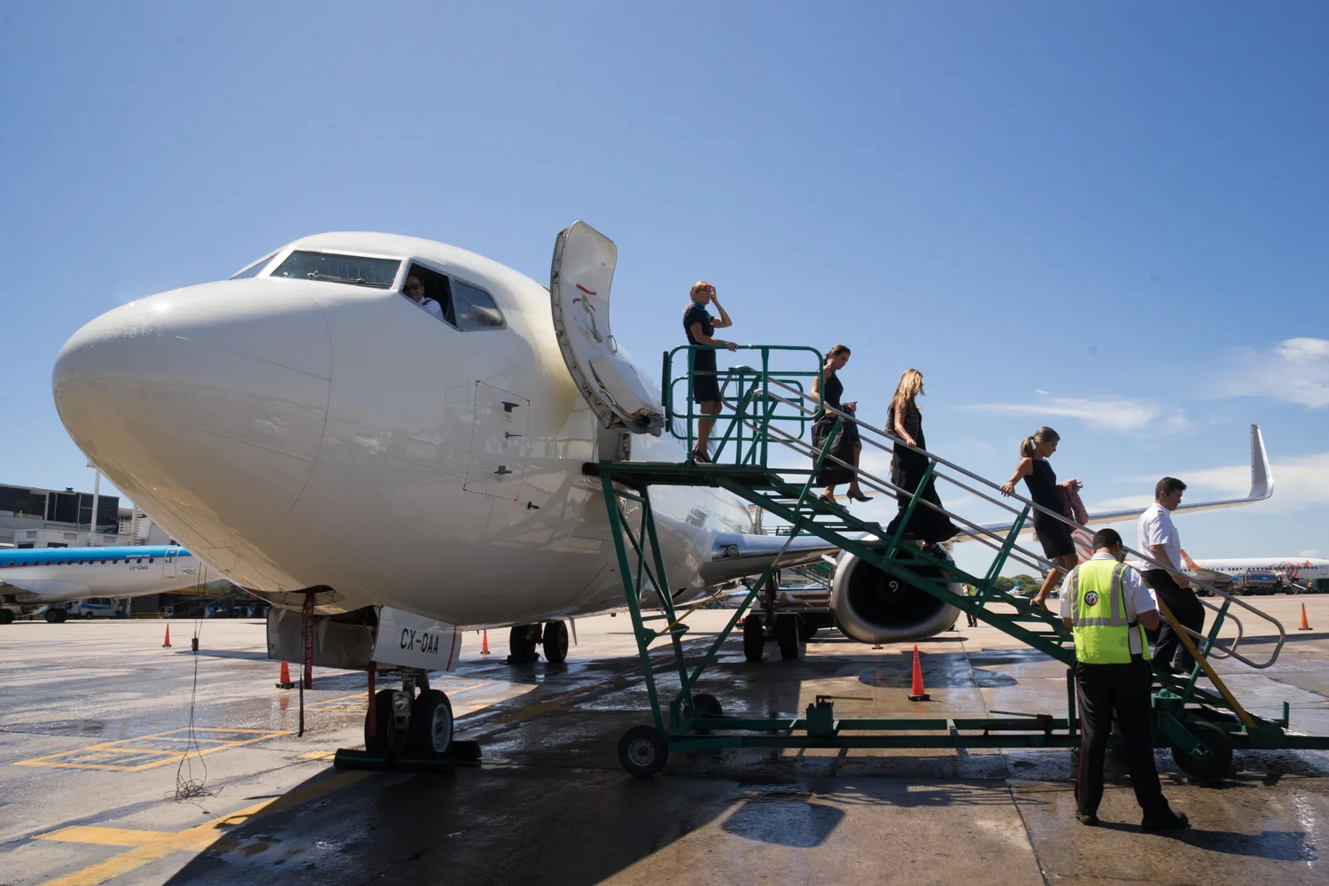 Flight attendants leave the Alas Uruguay airplane that just arrived to Buenos Aires for the first time. Alas Uruguay is a new cooperative airline. Buenos Aires, Argentina. January, 2016. For Bloomberg media