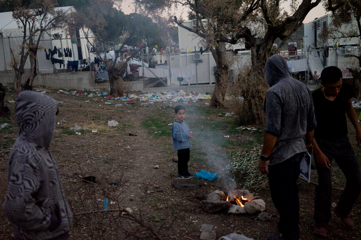 October 20, 2017. Syrians and Iraqis asylum seekers make a bonfire to cook and keep warm outside of the Moria hotspot. Moria, Lesbos, Greece. There is no system for heating and with winter approaching, residents sleeping in summer tents are worried, reminded of last winter when six people in the camp died because of the cold. 