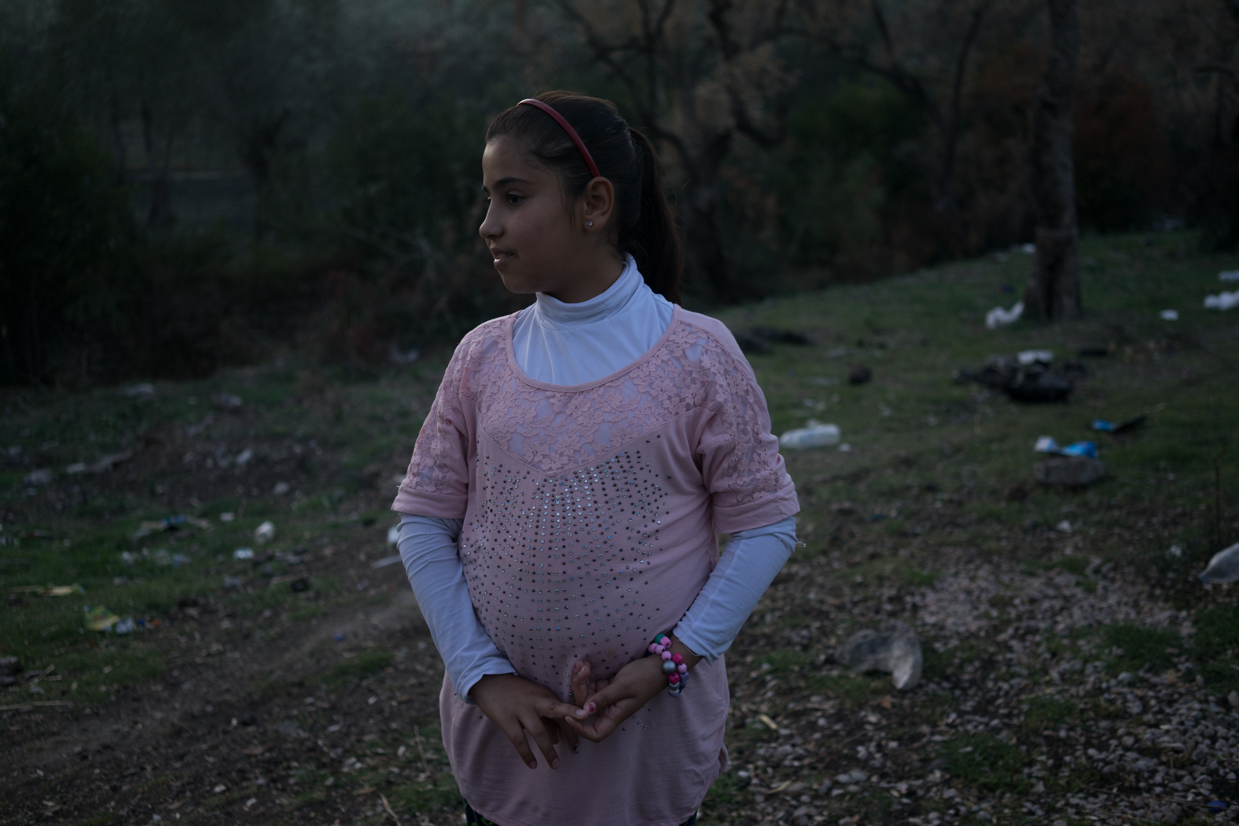 November 9, 2017. Moria camp Lesbos. Ally from Iraq poses for a photograph outside Moria camp. Her mother was killed in Iraq, she came to Europe with her brother and father, and they all have been waiting a year to move on. 