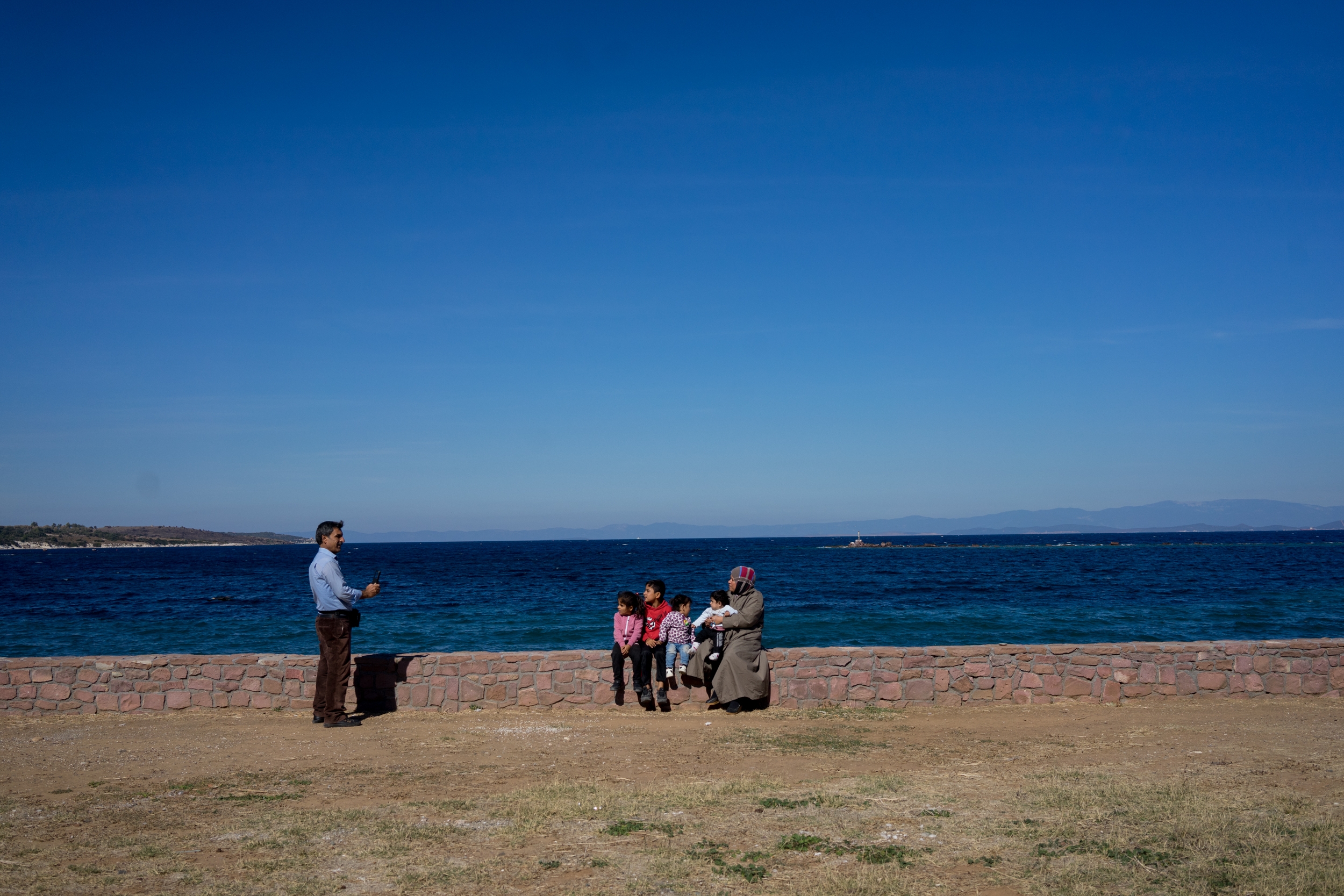 In 2015 borders within the EU were open, and within three days of making landfall refugees would get their papers, go to Athens and continue their journey, applying for asylum elsewhere in the EU. October 17, 2017. Mytilene, Lesbos. Greece. Moustafa from Kurdish Syria takes a picture of his family in his 10th day in Europe. ¨When we first arrived we were happy, but we want to continue, we don´t want to wait here¨