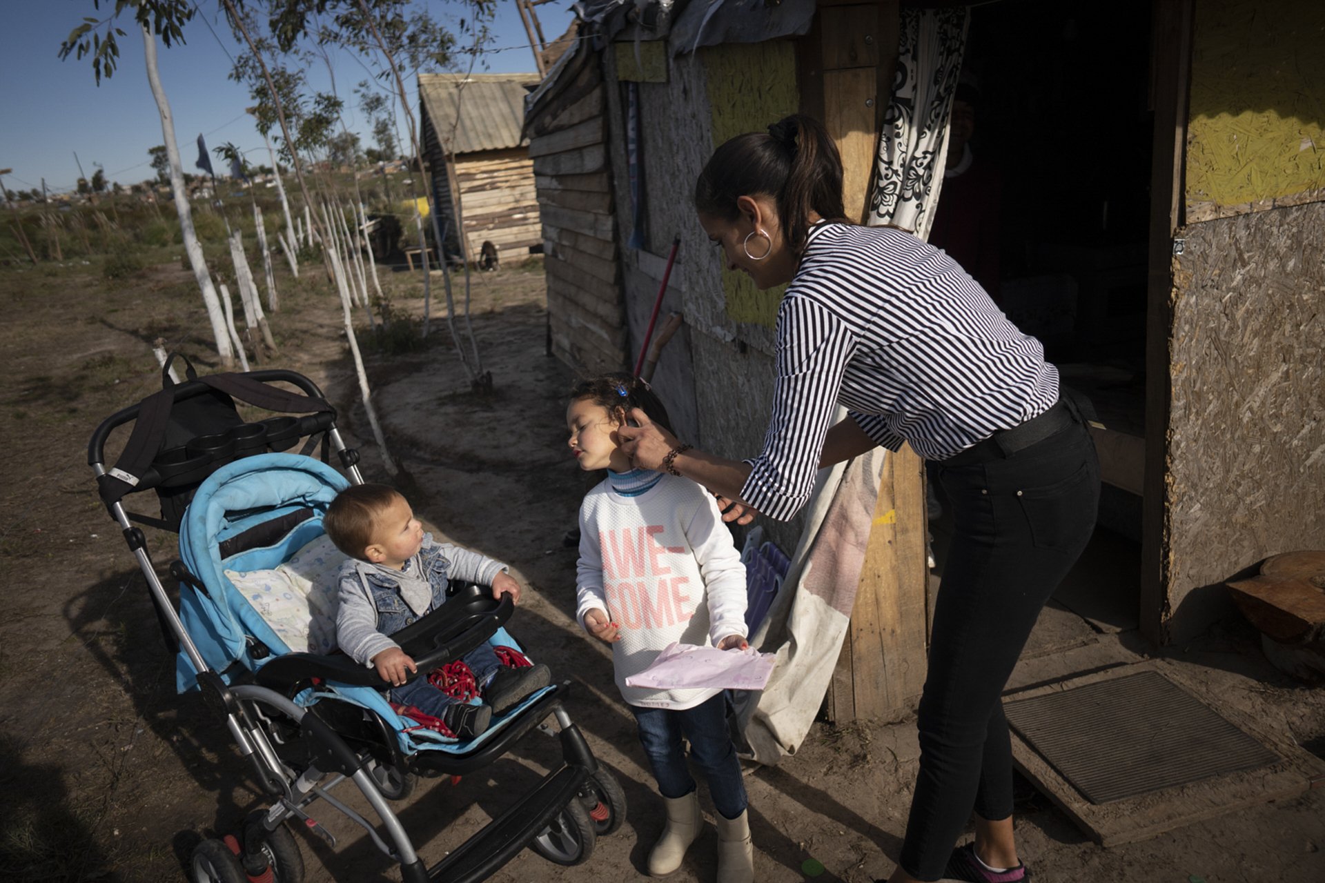 Tania gets her children ready to go to a birthday party. October 2020.