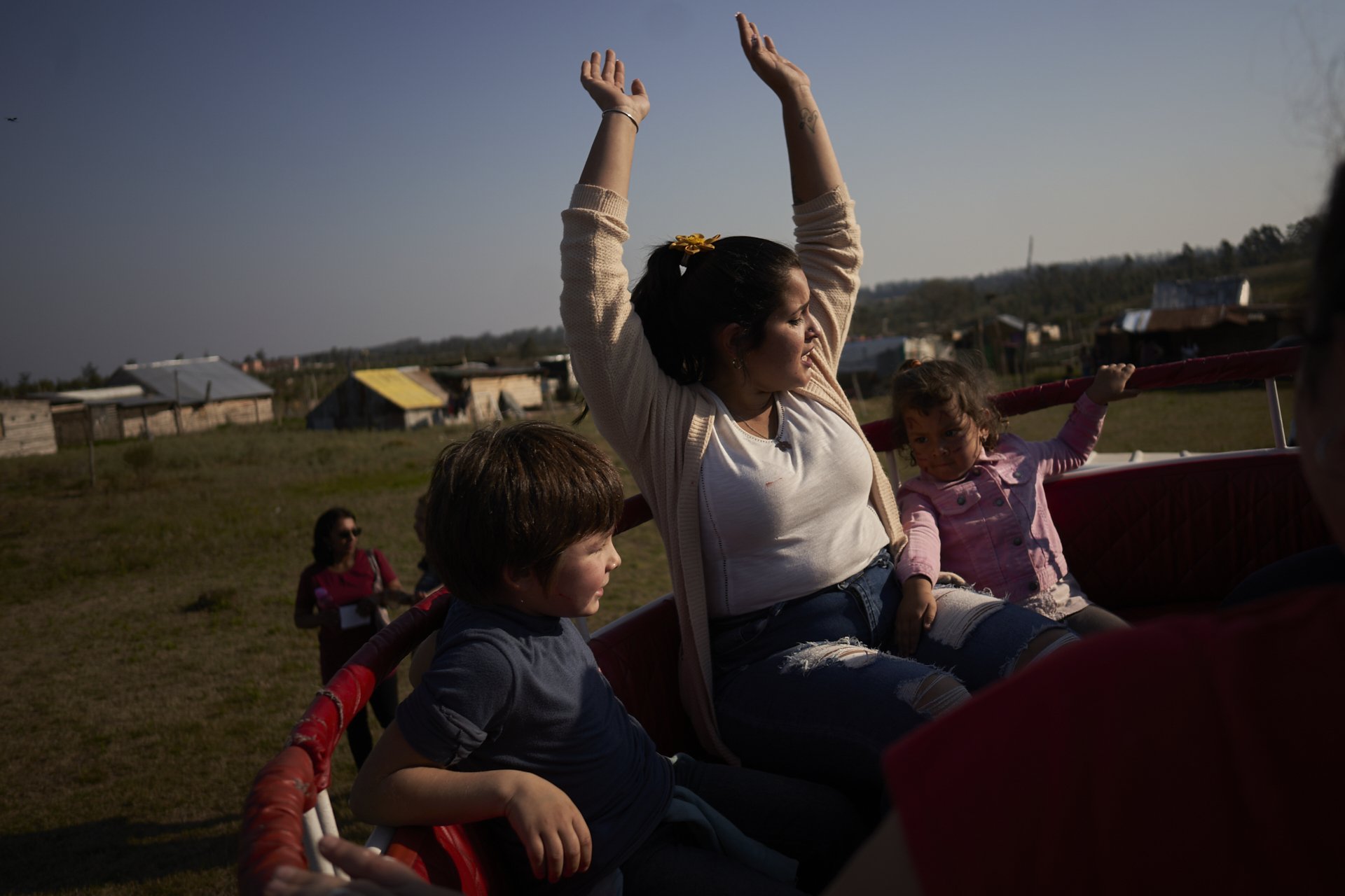 Romina and her children enjoy a game at a children’s day celebration. August 2021