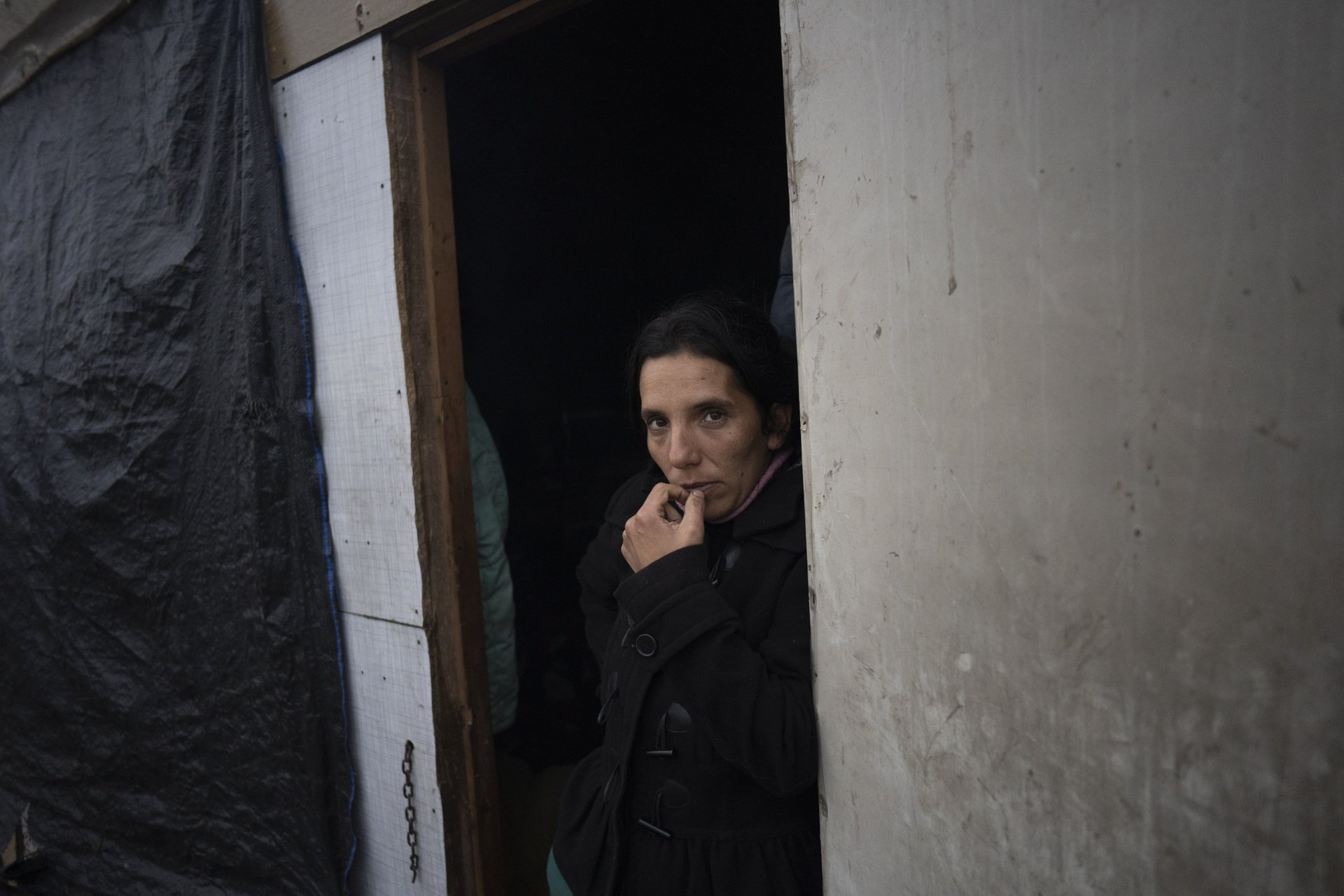 Leticia stands for a portrait, as she builds her home. May 2020