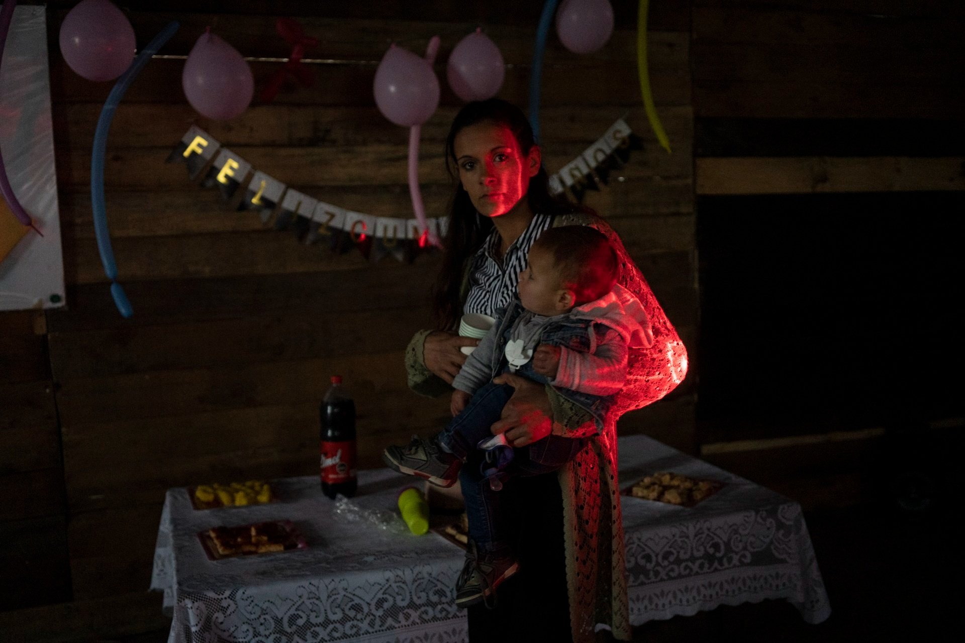 Tania with her son Bauti, sets up her daughter birthday celebration. June 2020 In January 2020, while the COVID-19 pandemic was reaching Montevideo, Uruguay, some families decided to occupy a piece of land that had been vacant for decades, and th