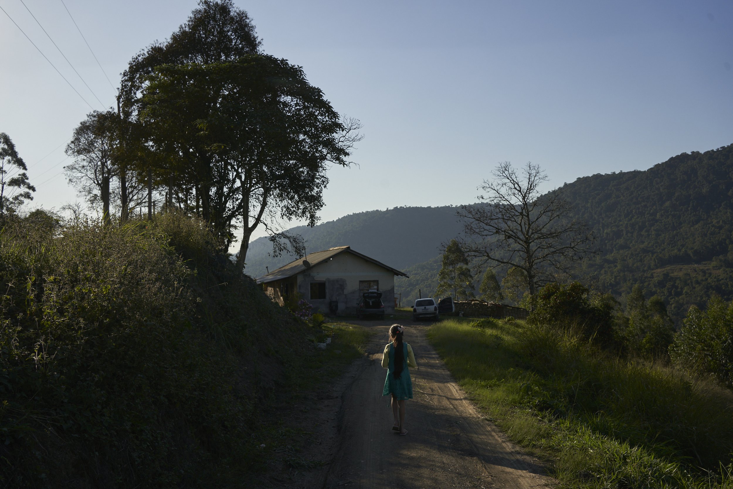 Tandara Katxa Maciel De Almeida walking home at the Ibirama-Laklãnõ Indigenous Territory. Indigenous Xokleng children lives continually fluctuate between feelings of fright and some degree of hope. The decision of the “marco temporal”, a cut-off