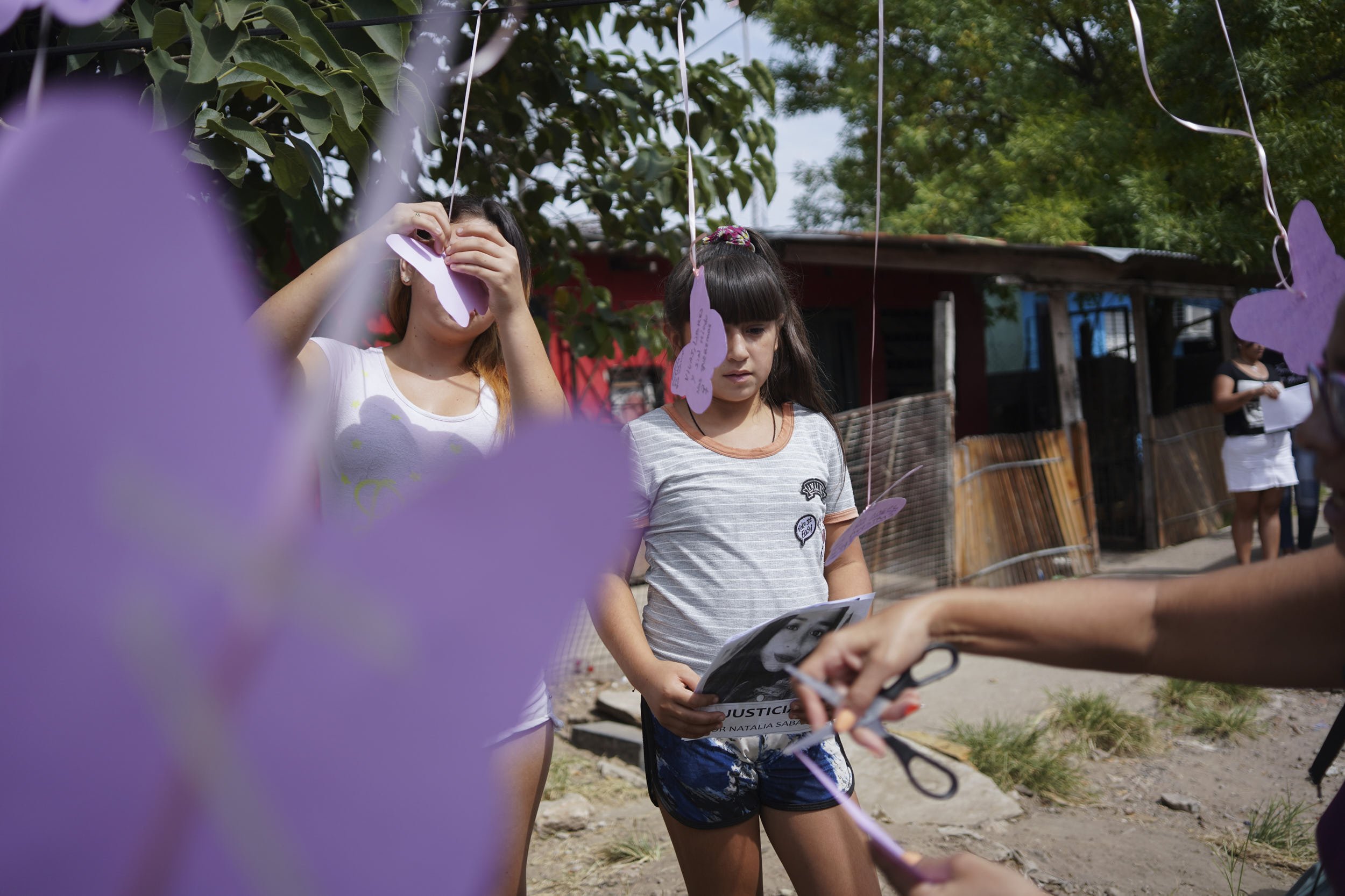 Girls write messages on paper butterflies at a gathering to demand justice for Natalia Saban, victim of femicide, who died after being shot at her boyfriend's home, in the Villa Hidalgo neighborhood, in Buenos Aires, Argentina March 8, 2020. REUTERS