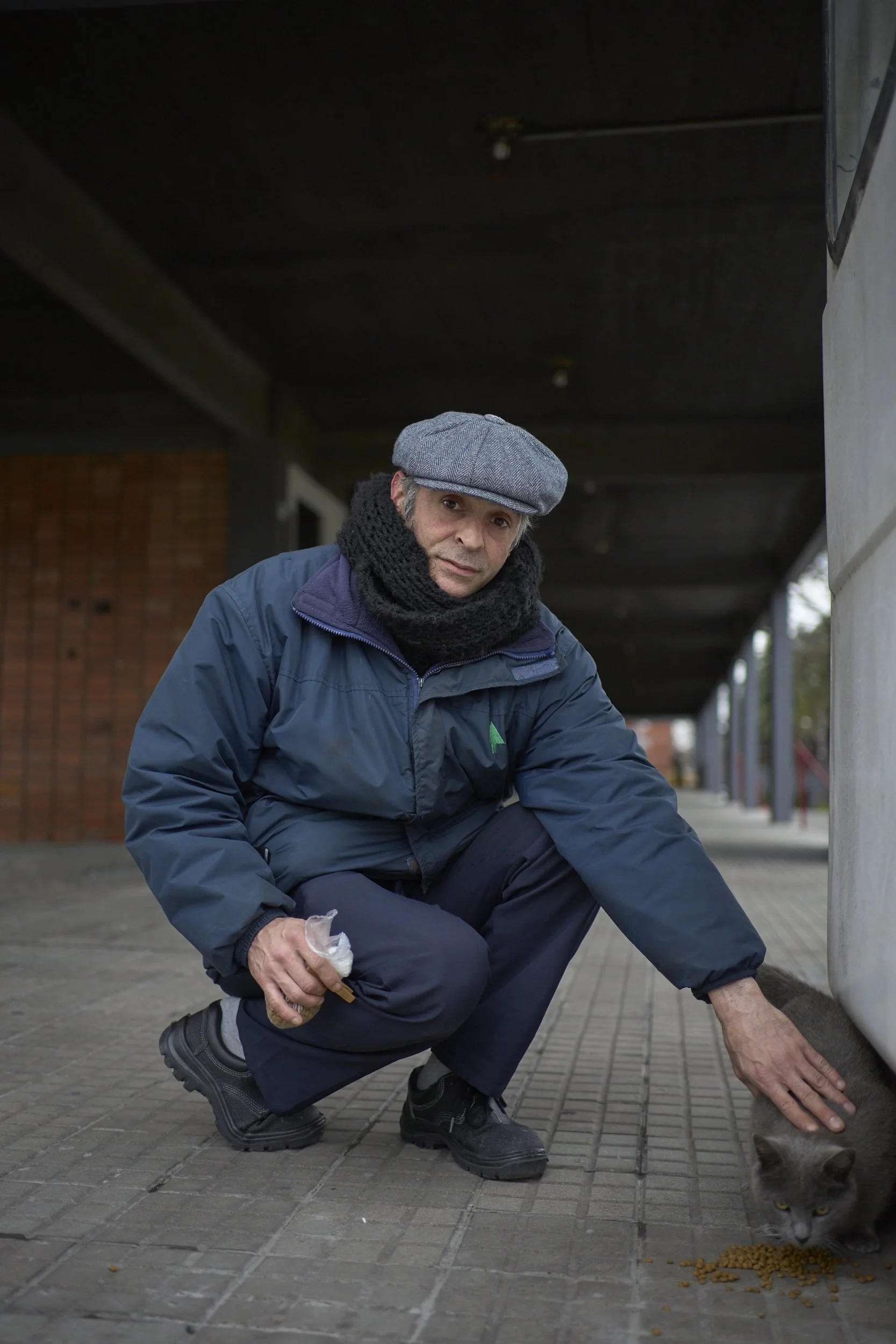  Mauro, one of the security guards, feeds a cat that lives in the area, he was born and raised in the complejo, now lives somewhere else, works there as a security and it’s also part of the community. 