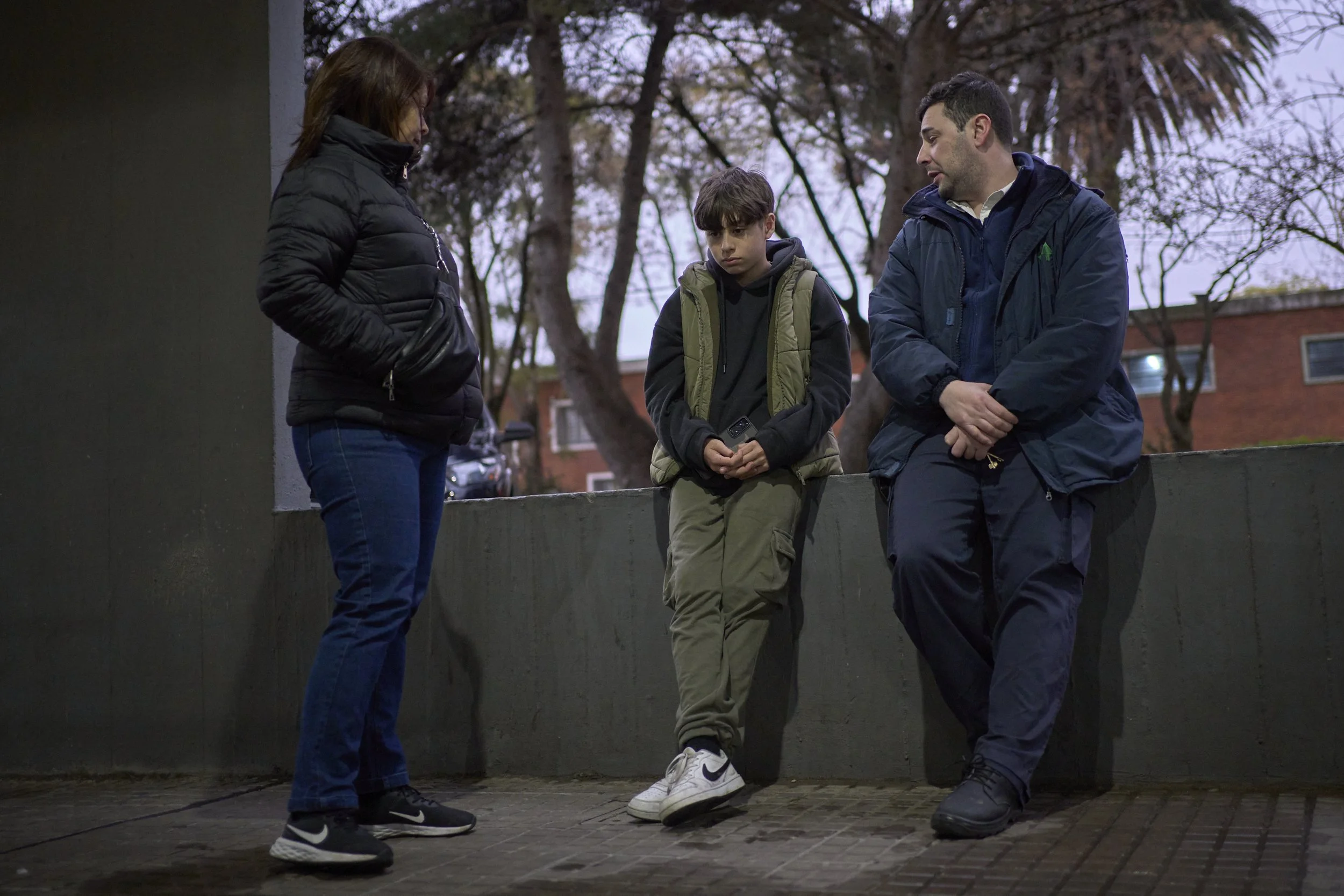  Manuel is being told off by his mother and the guard on duty, for an argument he had with a neighbor.  