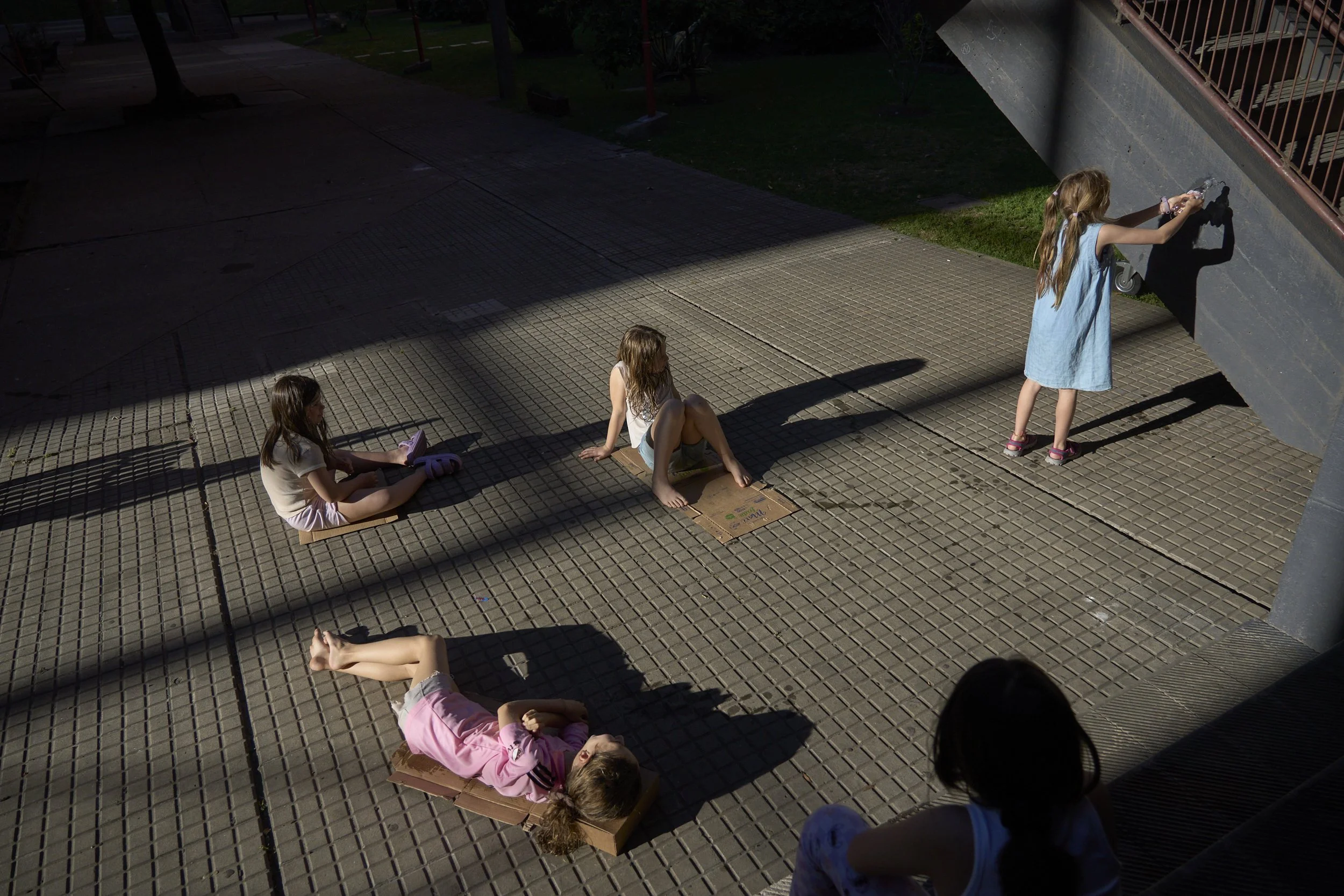  A group of kids dry out in the sun, after a water fight. 