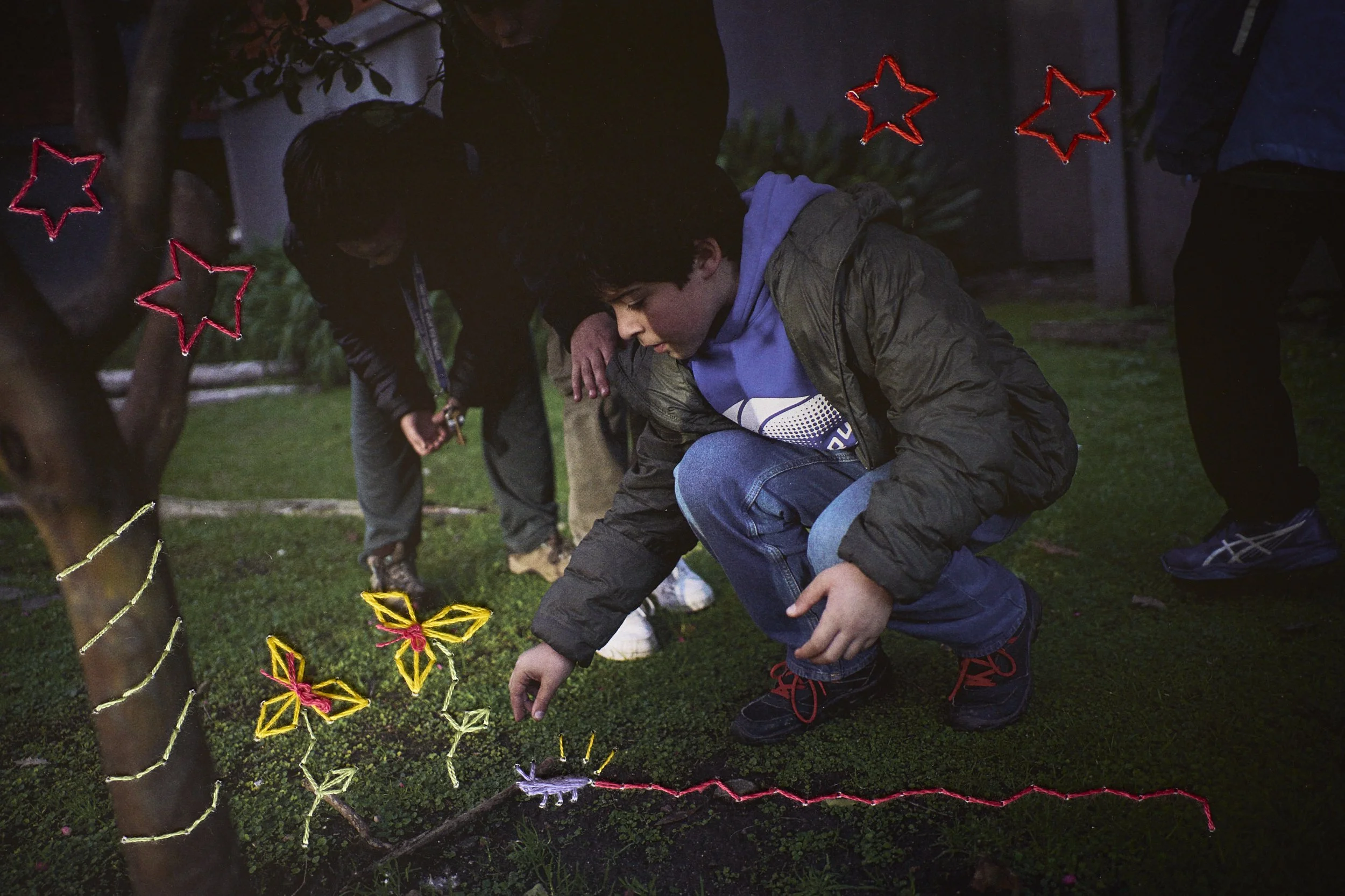  Alfonso and his friends play in the communal garden. Embroidery by Paula 