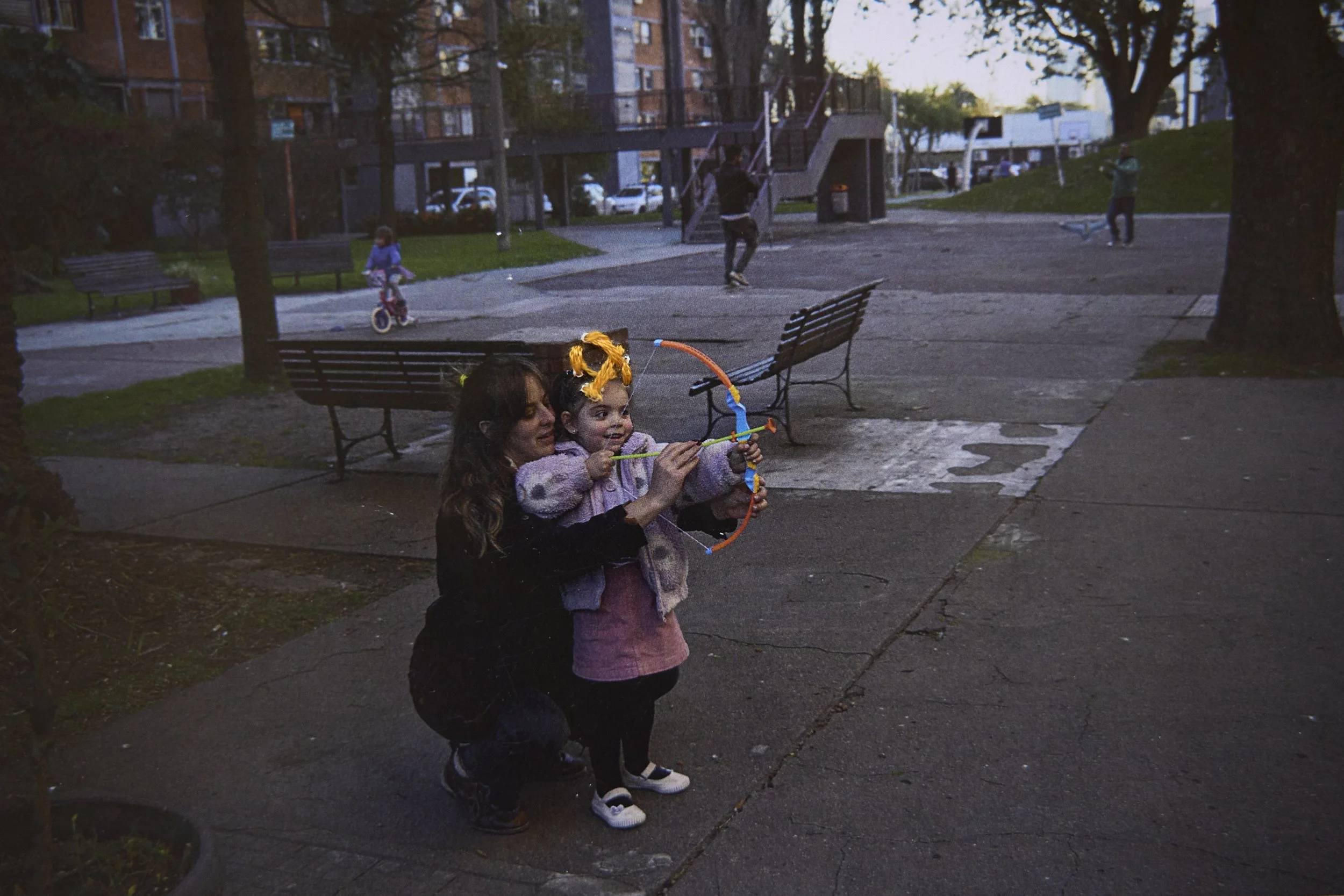  Martina learns how to use an arch with her mother, in the communal garden. Embroidery by Bruno. 