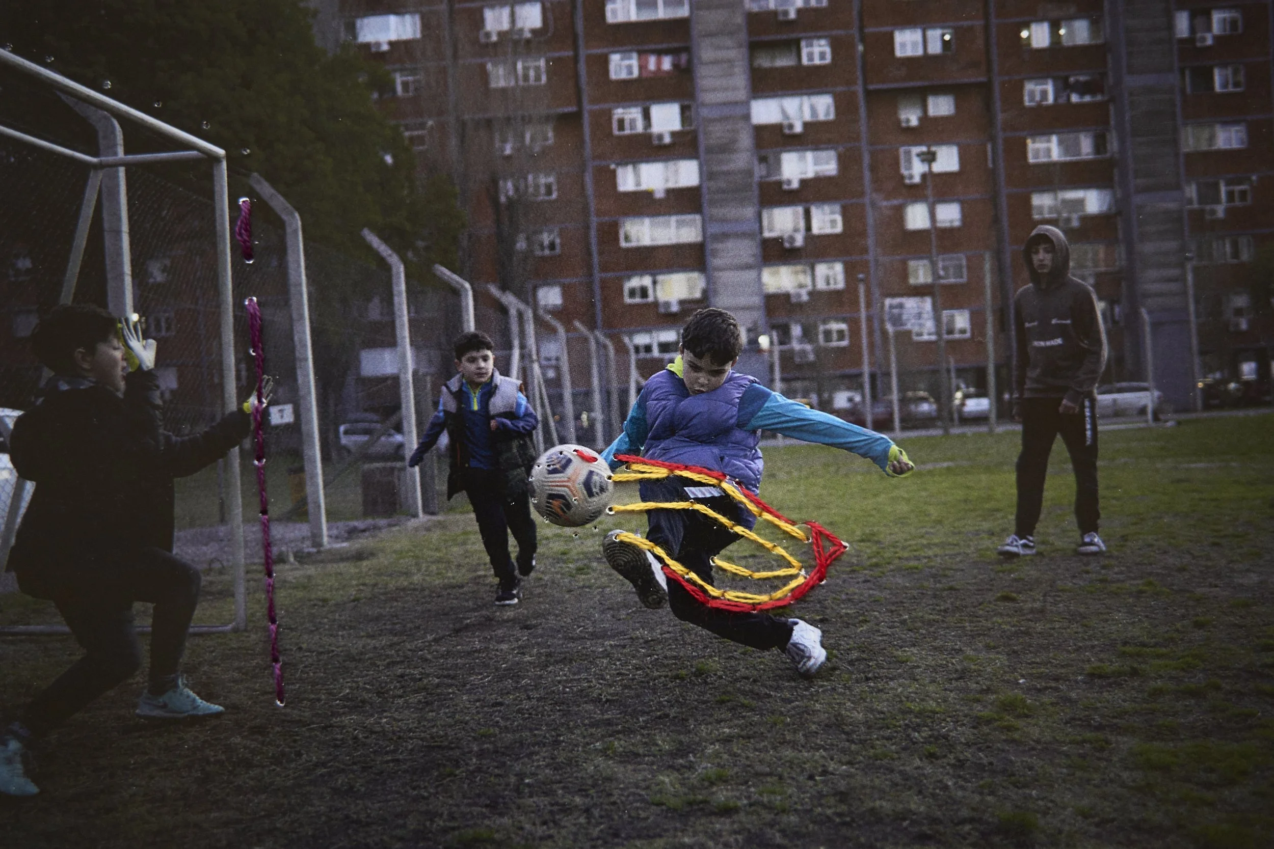  Kids play football in the common football court. Embroidery by Vicente and Alfonsina. 