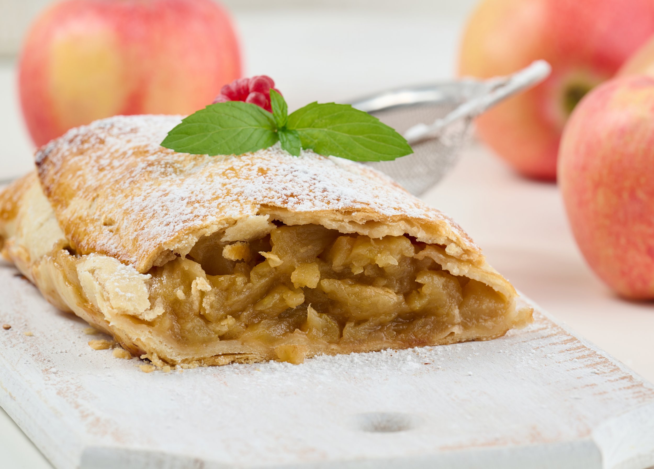 baked-strudel-with-apples-sprinkled-with-powdered-sugar-white-wooden-board-delicious-dessert.jpg