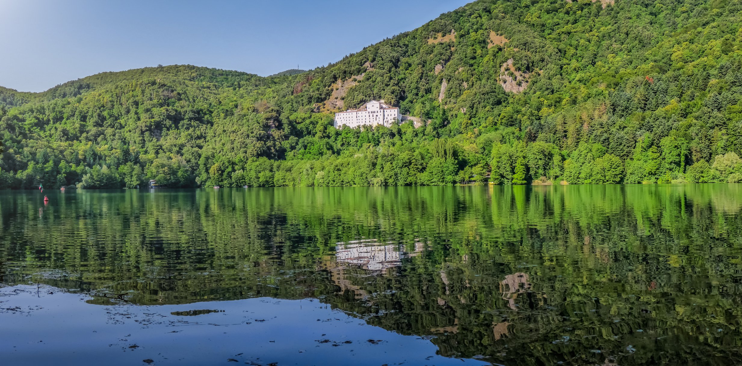 dreamstime_m_80964286 Monticchio Lake with famous Abbey and Monte Vulture, Basilicata by minnystock.jpg