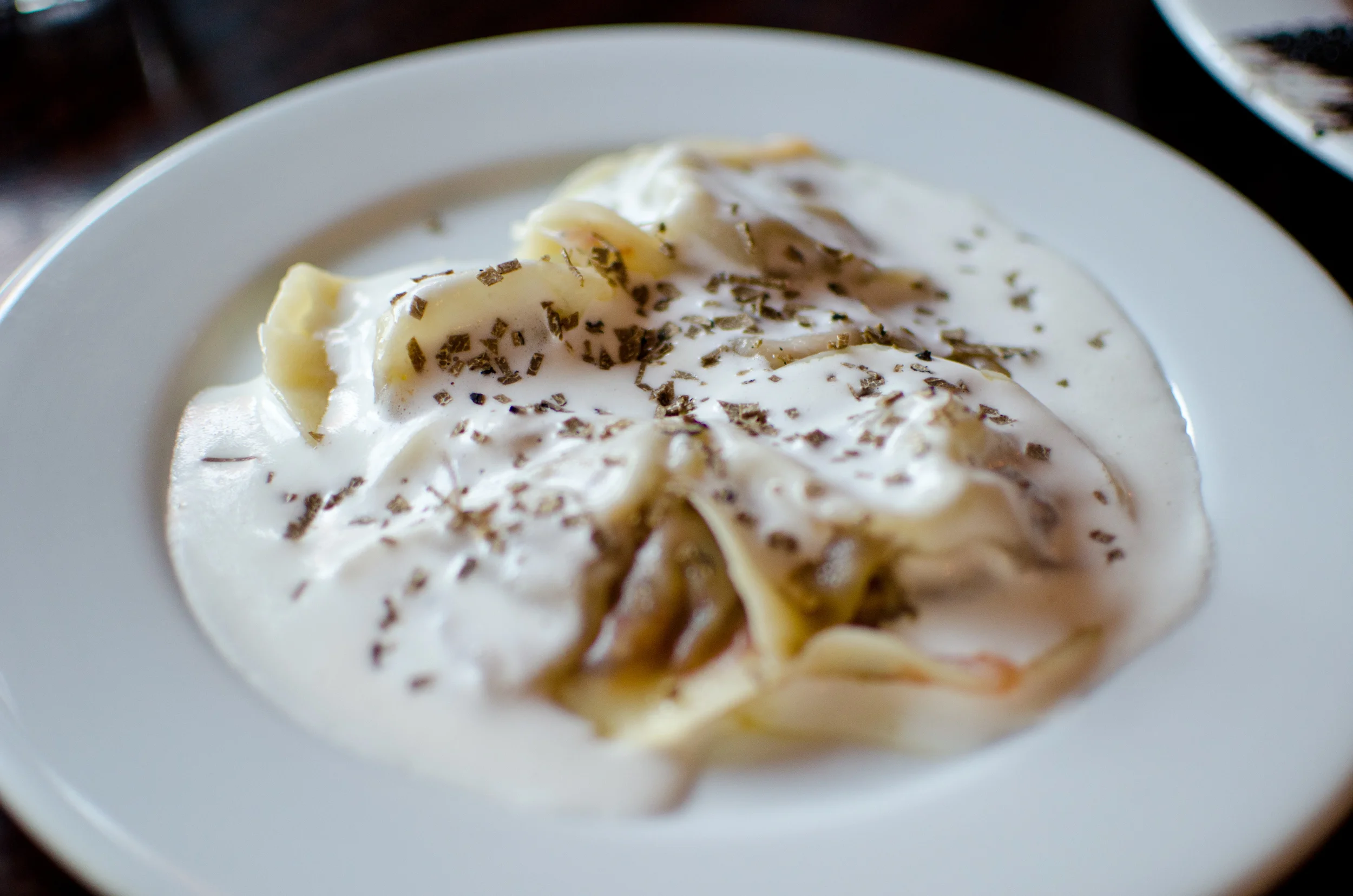 Foie gras ravioli, kimchi, sake black truffle cream