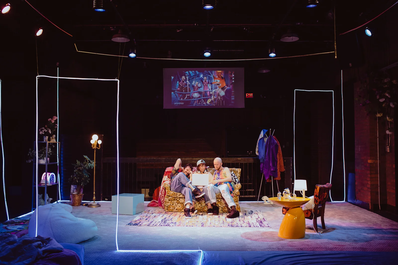 Photo by Tye Carson | Design by Alison Yanota | Projection design by Tyler Klein Longmire | Image of Joe Perry, Zoe Glassman, and Evan Medd