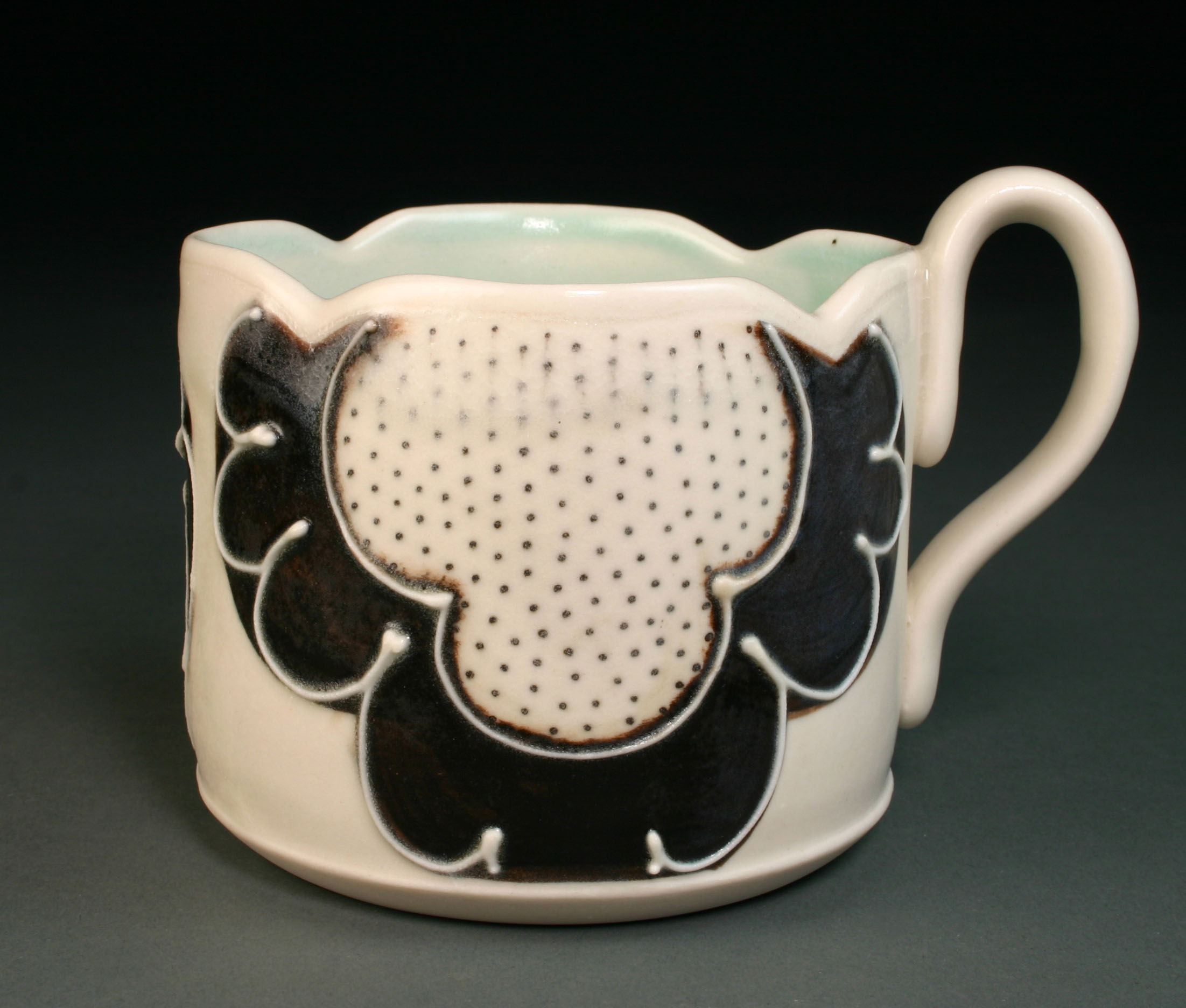  &nbsp;&nbsp;&nbsp;Porcelain decorated with hand drawn underglaze, slip trail, and glaze.  3.5" x 4" x 4" 