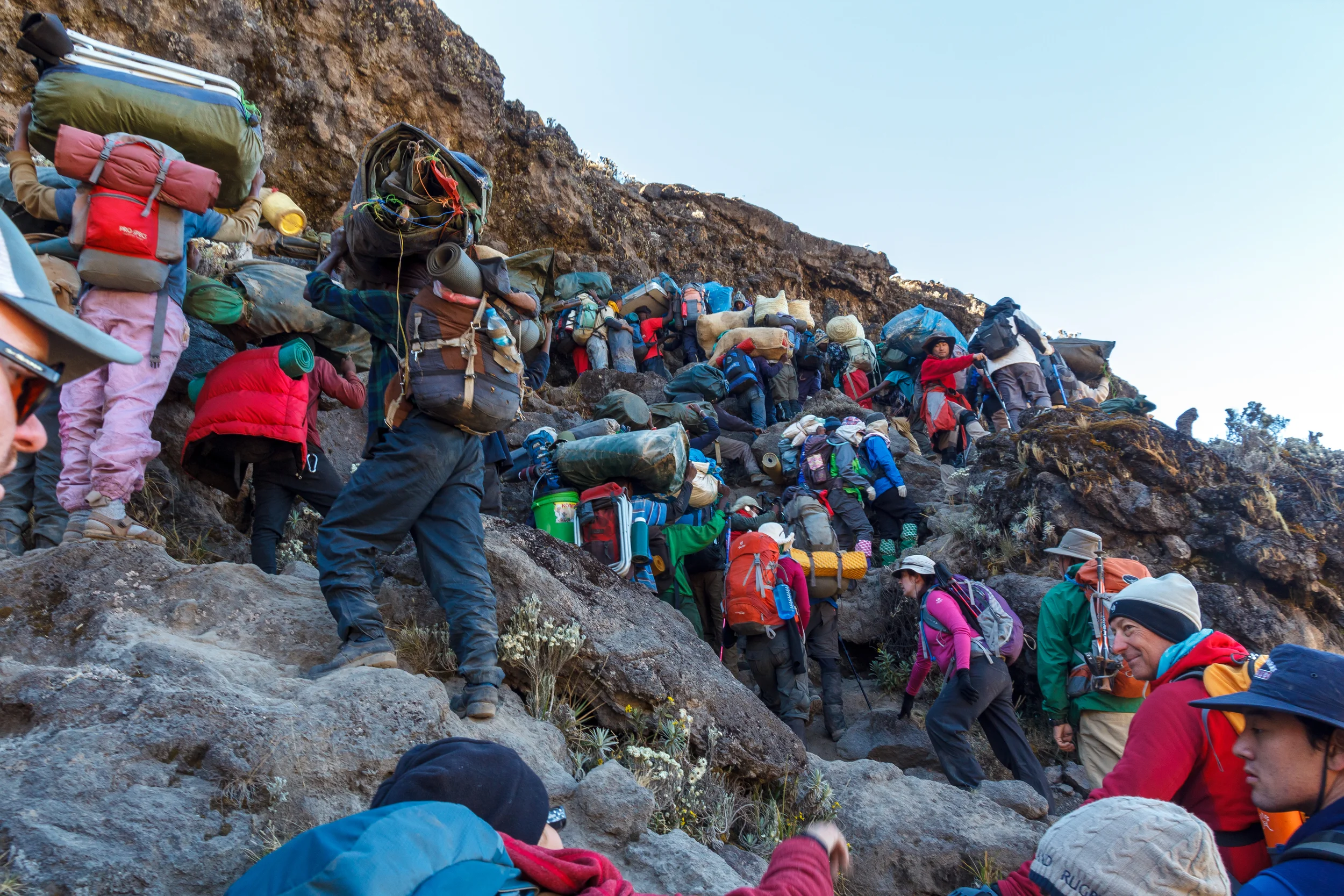 Porters traversing up the Barranco Wall 'Breakfast Wall' on Mt. Kilimanjaro - Photo Credit: Lincoln Chu