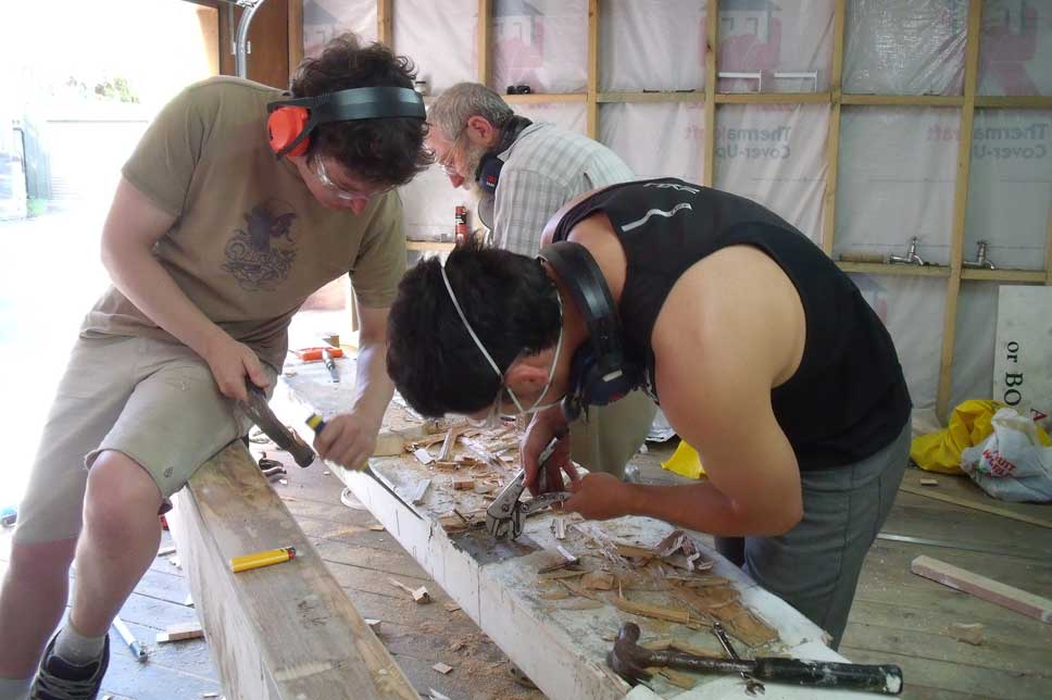    Removing fittings from the side of the old boat beams. 