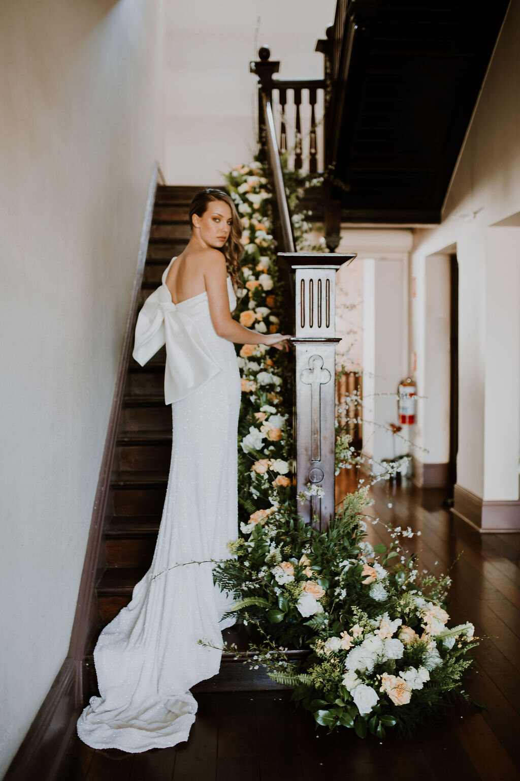 JL shoot bride staircase flowers.jpg