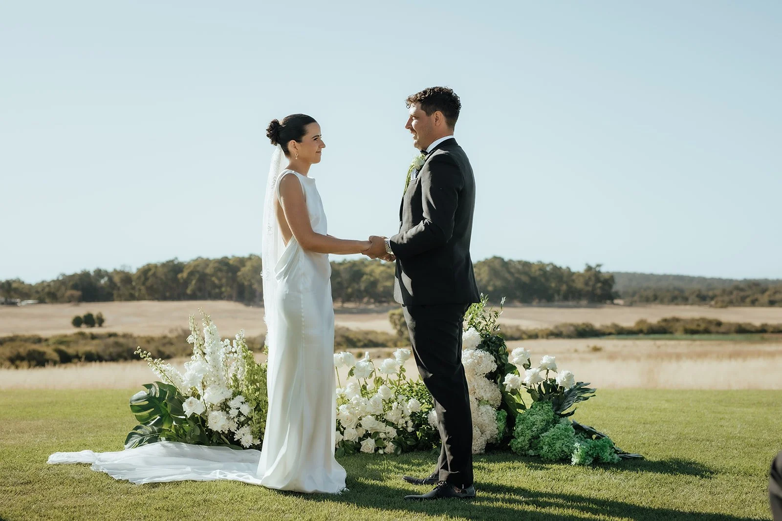 Lara-Brandon-ceremony-floral-arch-bride-groom.jpg