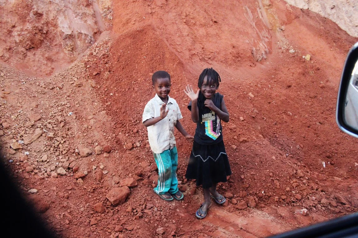 kids playing in the rubble of a roadworks site - we had to change our route at this point