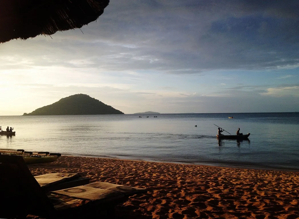 local fishermen rowing home at sunset