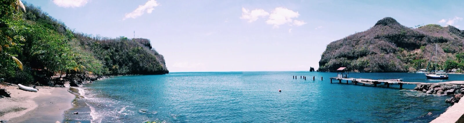 Wallilabou pano: mini Melody tender on the beach (left) and Melody mamma in the bay (right)