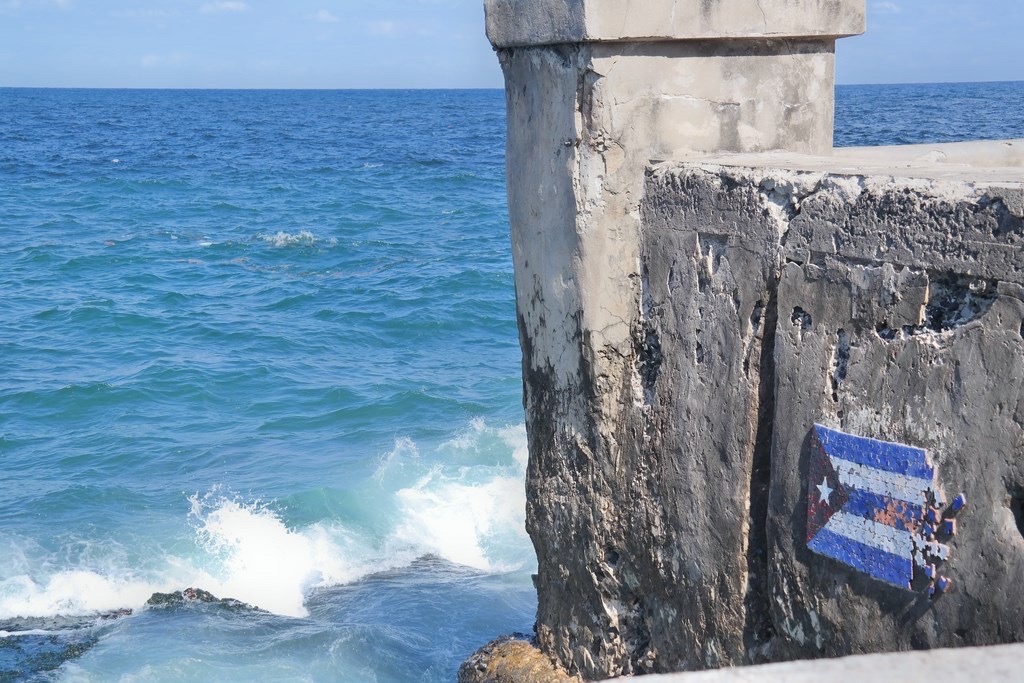 part of the wall of the Malecon with a local artist's interpretation of the Cuban flag