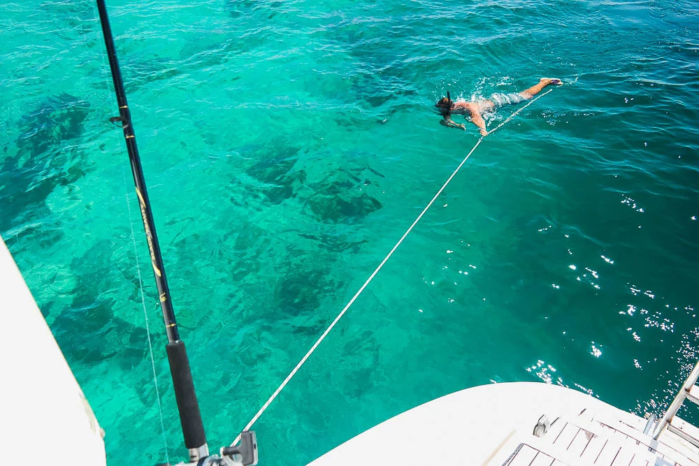 Rufus, our human fish finder, scouting for good snorkelling spots while we are under way