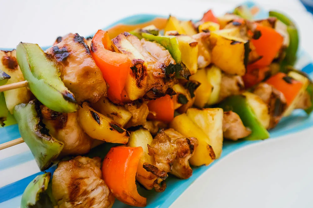 you can take us out of South Africa but you can't take us away from the braai! this is one of our favourite charter meals to prepare: chicken, sweet pepper and pineapple sosaties (kebabs) on the ideally charcoal, not gas, braai (barbecue)