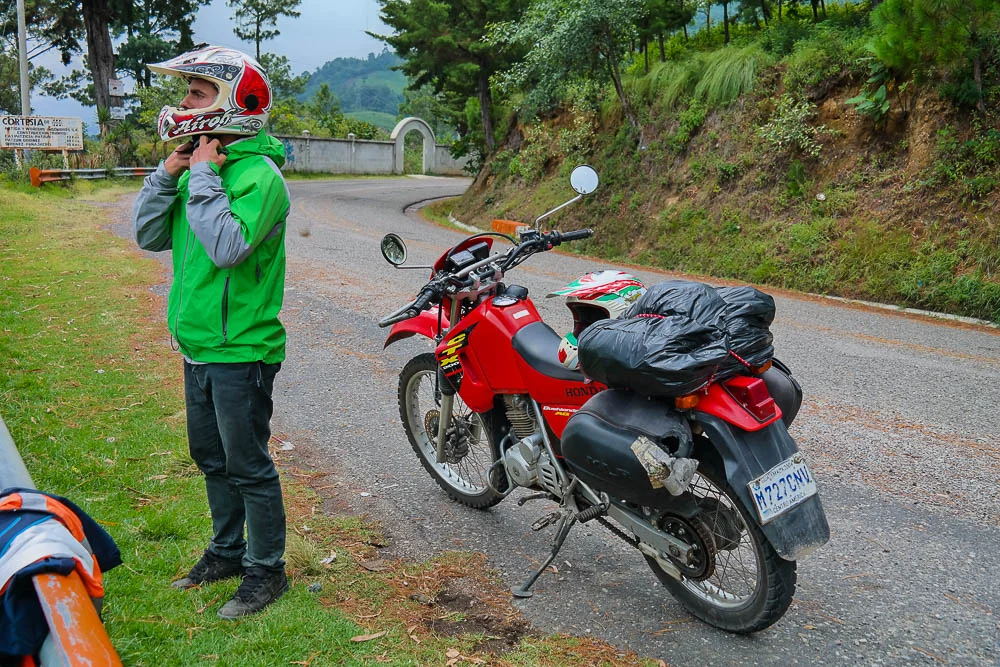 ready to get back on the road with our humble black bag wrapped backpack strapped to the bike's booty